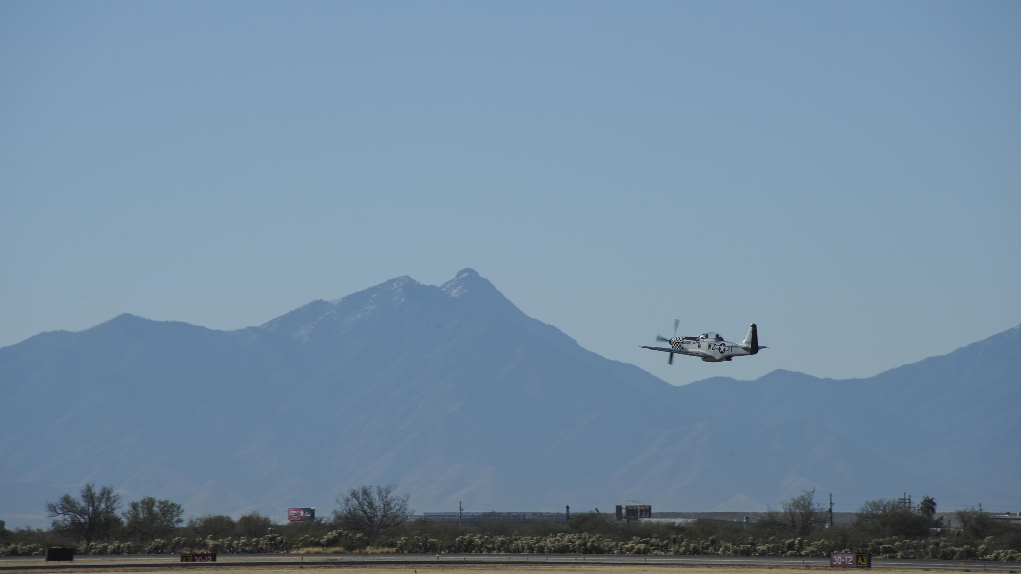 A TF-51 Mustang flies during the 2017 Heritage Flight Training and Certification Course at Davis-Monthan Air Force Base, Ariz., Feb. 10, 2017. During the course, aircrews practice ground and flight training to enable civilian pilots of historic military aircraft and Air Force pilots of current fighter aircraft to fly safely in formations together. (U.S. Air Force photo by Airman 1st Class Mya M. Crosby)