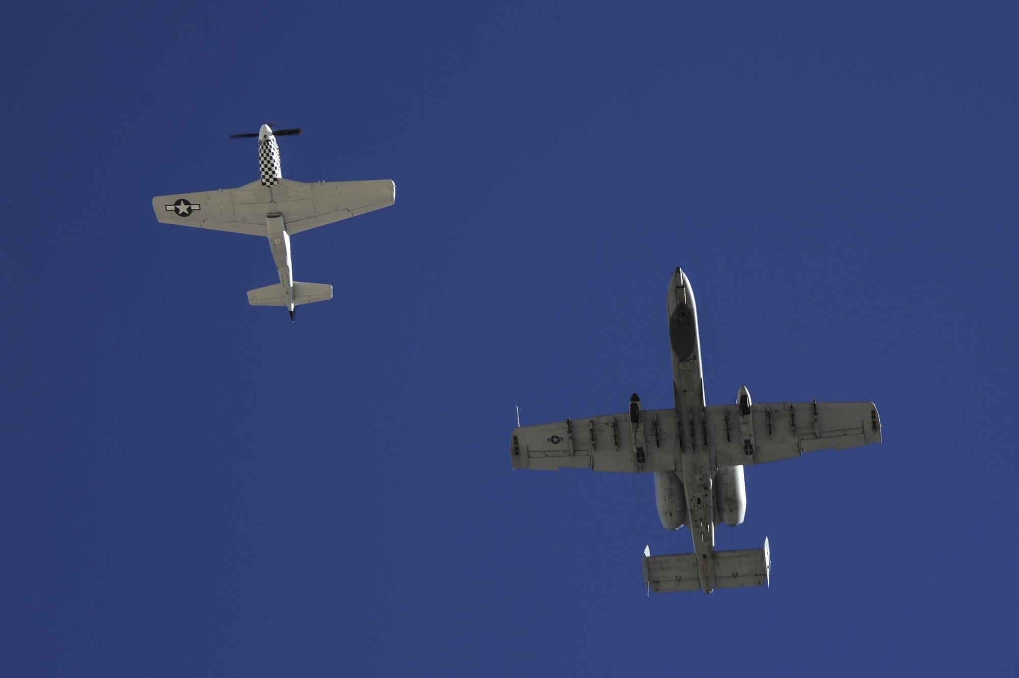 A U.S. Air Force A-10C Thunderbolt II and a TF-51 fly together during the 2017 Heritage Flight Training and Certification Course at Davis-Monthan Air Force Base, Ariz., Feb. 10, 2017. The course certifies civilian pilots of historic military aircraft and Air Force pilots to fly in formation together during the upcoming air show season. (U.S. Air Force photo by Airman 1st Class Mya M. Crosby)