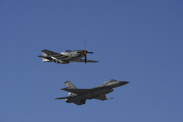 A P-51 Mustang and a U.S. Air Force F-16 Fighting Falcon preform a fly over during the 2017 Heritage Flight Training and Certification Course at Davis-Monthan Air Force Base, Ariz., Feb. 10, 2017. During the course, aircrews practice ground and flight training to enable civilian pilots of historic military aircraft and U.S. Air Force pilots of current fighter aircraft to fly safely in formations together. (U.S. Air Force photo by Senior Airman Ashley N. Steffen)