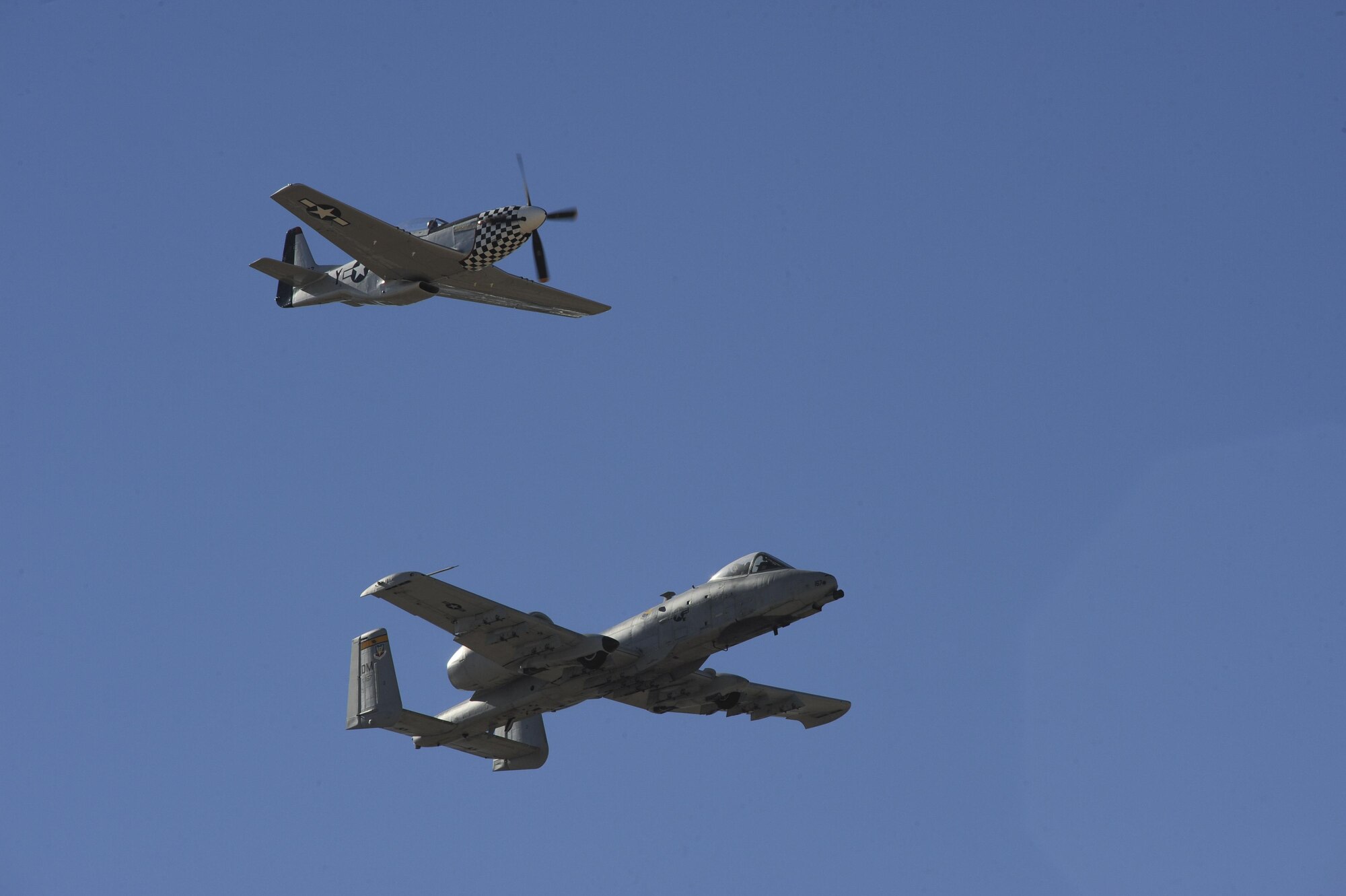 A P-51 Mustang and U.S. Air Force A-10C Thunderbolt II fly in formation during the 2017 Heritage Flight Training and Certification Course at Davis-Monthan Air Force Base, Ariz., Feb., 10, 2017. Established in 1997, the HFTCC certifies civilian pilots of historic military aircraft and U.S. Air Force pilots to fly in formation together during the upcoming air show season. (U.S. Air Force photo by Senior Airman Ashley N. Steffen)