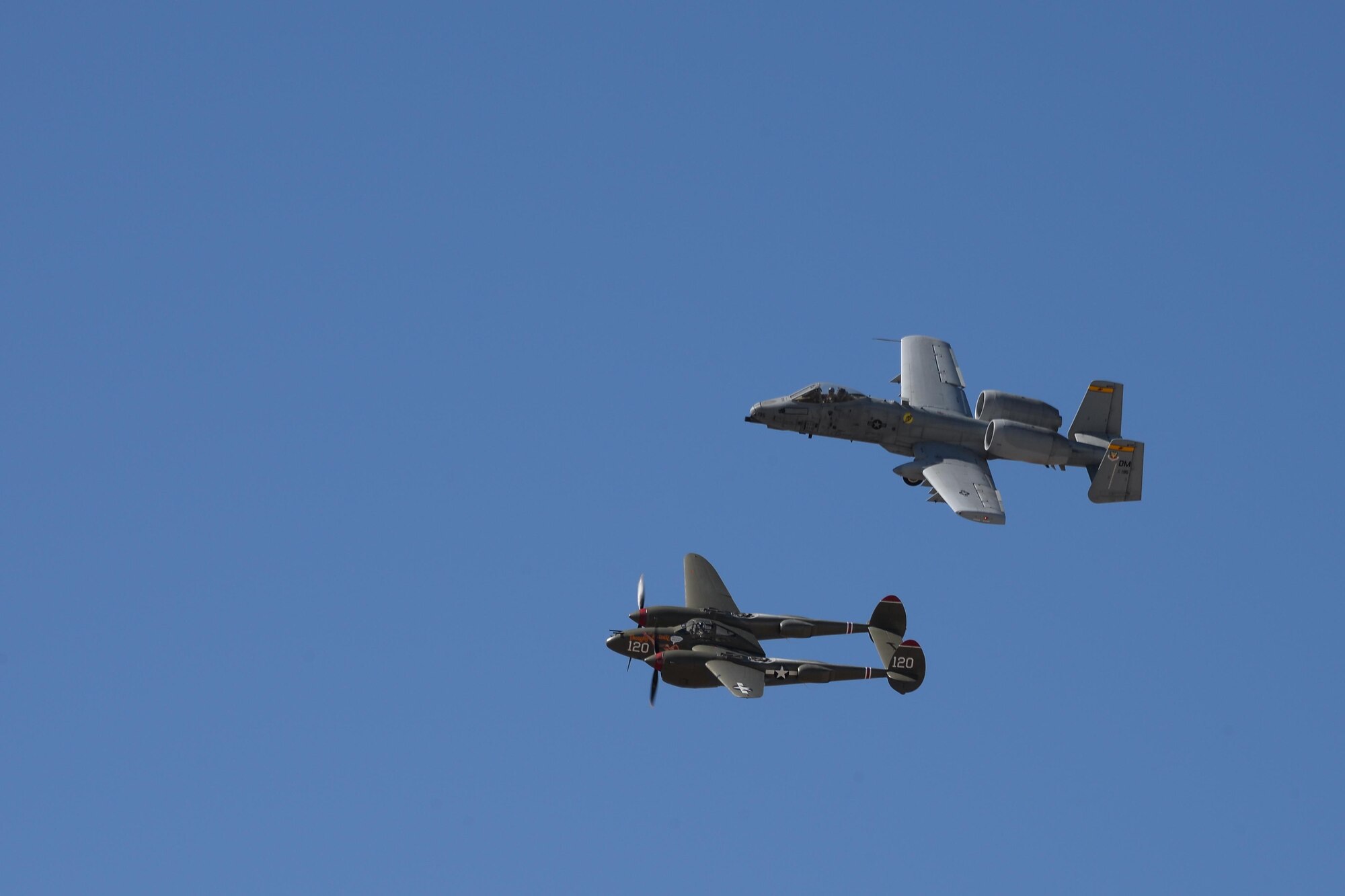 A U.S. Air Force A-10C Thunderbolt II and a P-38 Lightning fly in formation during the 2017 Heritage Flight Training and Certification Course at Davis-Monthan Air Force Base, Ariz., Feb. 10, 2017. During the course, aircrews practice ground and flight training to enable civilian pilots of historic military aircraft and U.S. Air Force pilots of current fighter aircraft to fly safely in formations together. (U.S. Air Force photo by Senior Airman Ashley N. Steffen)