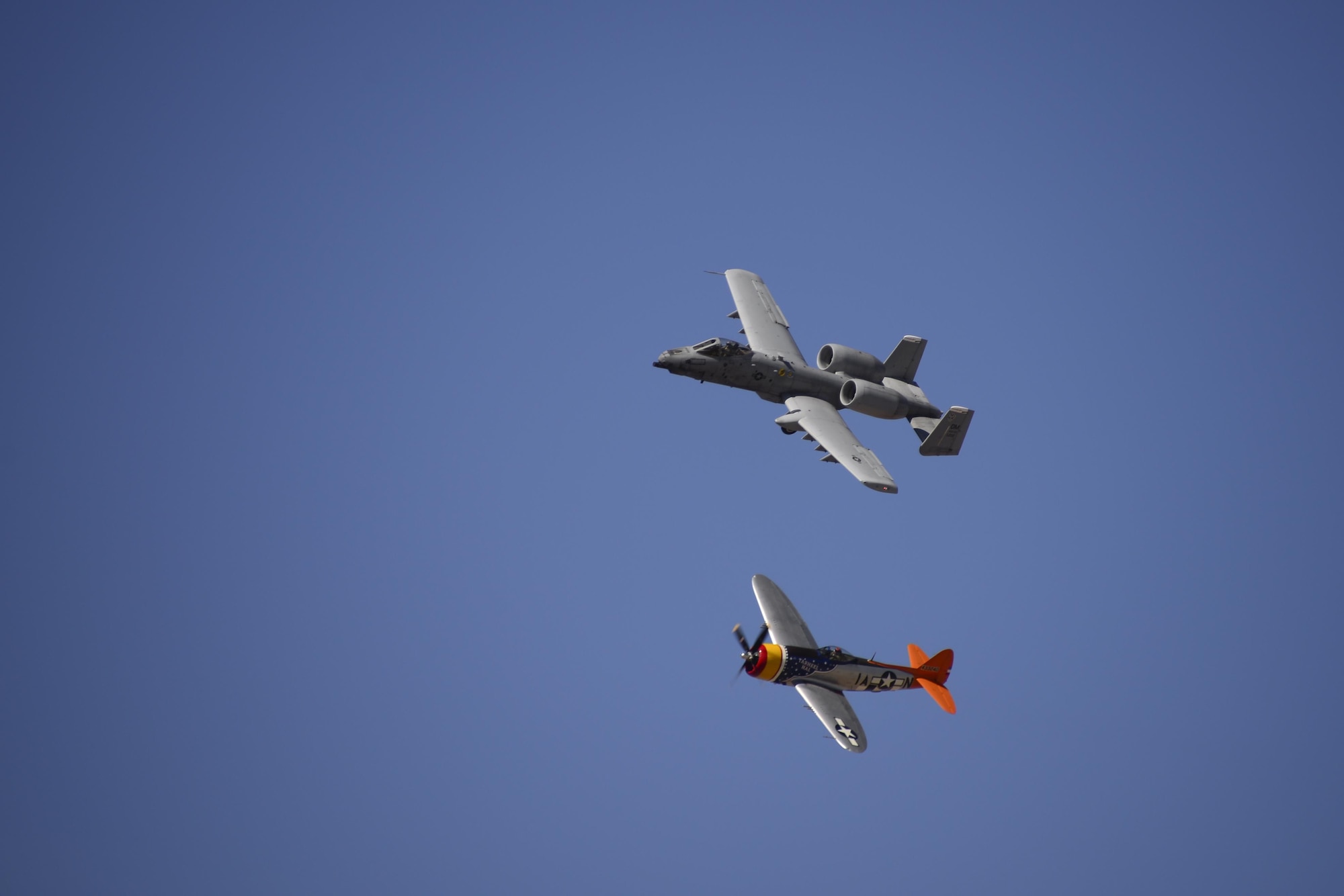 A U.S. Air Force A-10C Thunderbolt II and a P-47 Thunderbolt fly in formation during the 2017 Heritage Flight Training and Certification Course at Davis-Monthan Air Force Base, Ariz., Feb. 10, 2017. During the course, aircrews practice ground and flight training to enable civilian pilots of historic military aircraft and U.S. Air Force pilots of current fighter aircraft to fly safely in formations together. (U.S. Air Force photo by Senior Airman Betty R. Chevalier)
