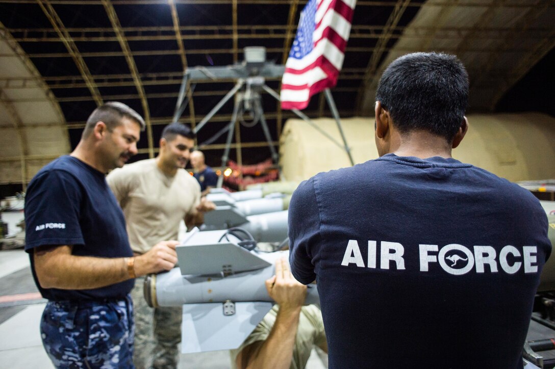 Members of the Royal Australian Air Force and U.S. Air Force construct Joint Direct Attack Munitions at an undisclosed location in Southwest Asia, Feb. 9, 2016. The RAAF has employed more than 1,600 munitions against ISIS since 2014. (U.S. Air Force photo/Senior Airman Tyler Woodward)