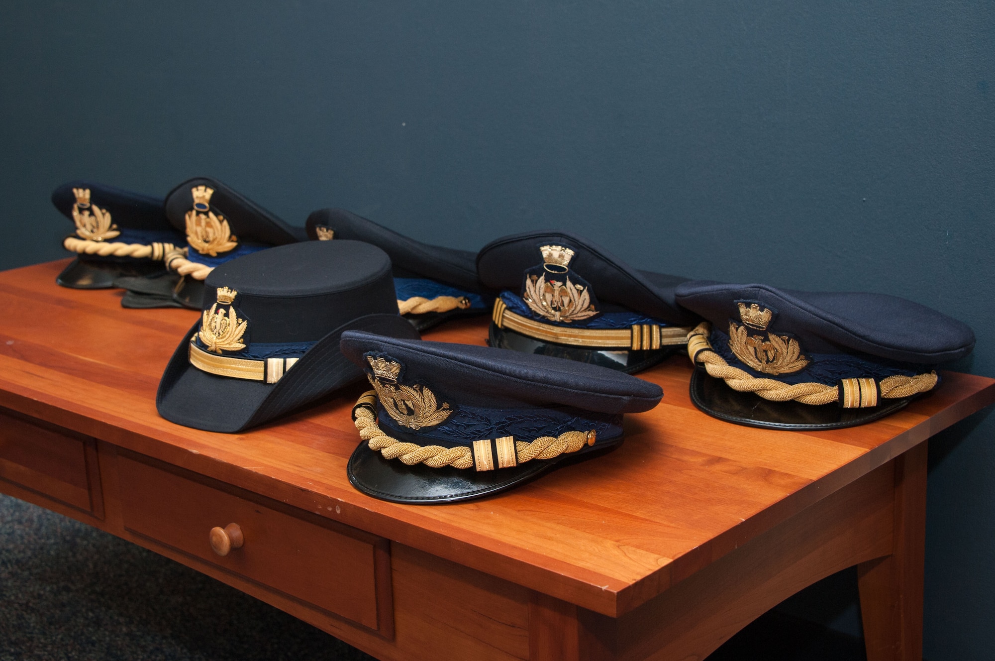 International Officers placed their uniformed hats on a table during the International Honor Roll Induction Ceremony at the International Officer School on Maxwell Air Force Base, Ala., on Feb. 10, 2017. The International Honor Roll program recognizes Air University international officer graduates who have attained a prominent position in their country, as well as their accomplishments as Air University international military students. (US Air Force photo by Bud Hancock)