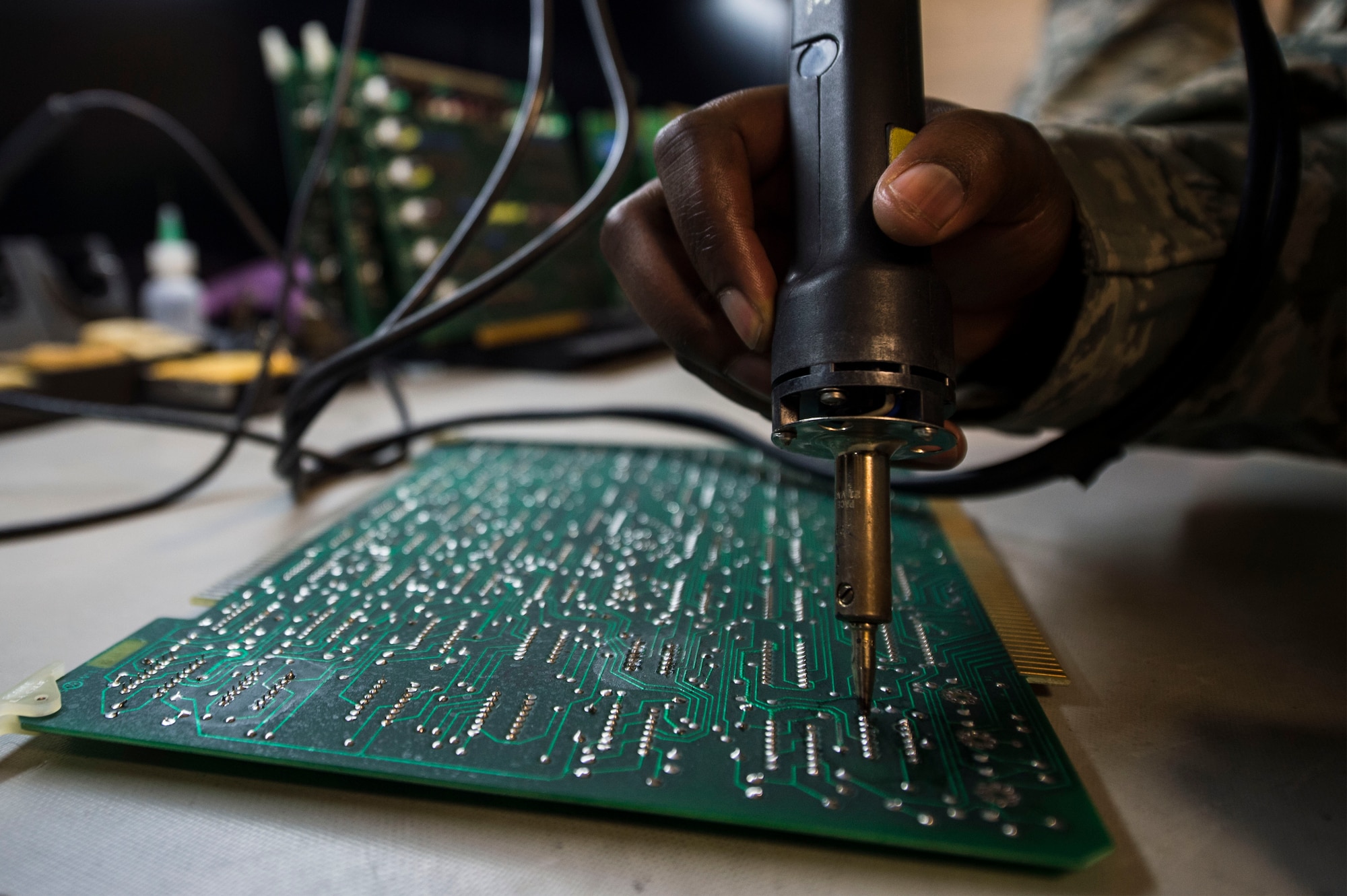 Staff Sgt. Dorian Howard, Air Force Nuclear Weapons Center soldering technical advisor, repairs a Minuteman III power processer circuit board at F.E. Warren Air Force Base, Wyo., Feb. 1, 2017. The AFNWC electronic laboratory on F.E. Warren tests and repairs the circuit boards for all three intercontinental ballistic missile wings. The Infrastructure and Equipment Division ensures that facility and infrastructure requirements are in place to support the ICBM systems across every missile complex.  (U.S. Air Force photo by Staff Sgt. Christopher Ruano)