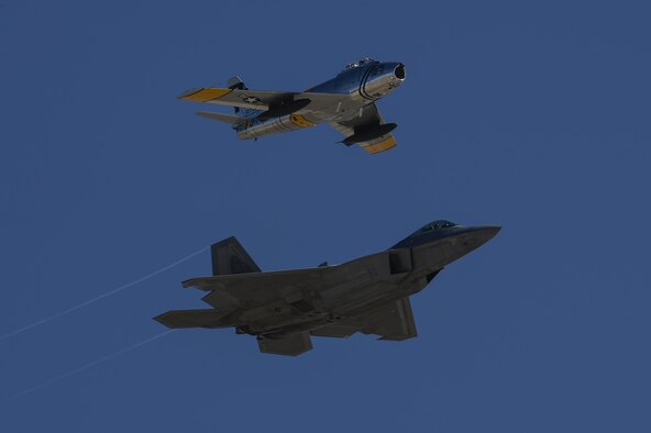 A U.S. Air Force F-22 Raptor and an F-86 Sabre fly together during the 2017 Heritage Flight Training and Certification Course at Davis-Monthan Air Force Base, Ariz., Feb. 10, 2017. During the course, aircrews practice ground and flight training to enable civilian pilots of historic military aircraft and U.S. Air Force pilots of current fighter aircraft to fly safely in formations together. (U.S. Air Force photo by Senior Airman Chris Drzazgowski)