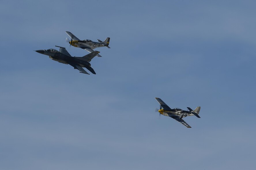 A U.S. Air Force F-16 Fighting Falcon and two P-51 Mustangs fly together during the 2017 Heritage Flight Training and Certification Course at Davis-Monthan Air Force Base, Ariz., Feb. 10, 2017. During the course, aircrews practice ground and flight training to enable civilian pilots of historic military aircraft and U.S. Air Force pilots of current fighter aircraft to fly safely in formations together. (U.S. Air Force photo by Senior Airman Chris Drzazgowski)