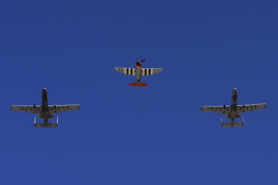 Two U.S. Air Force A-10C Thunderbolt IIs and a P-47 Thunderbolt fly together during the 2017 Heritage Flight Training and Certification Course at Davis-Monthan Air Force Base, Ariz., Feb. 10, 2017. The 20th annual training event has been held at D-M since 2001 and features aerial demonstrations from historical and modern fighter aircraft. (U.S. Air Force photo by Senior Airman Chris Drzazgowski)