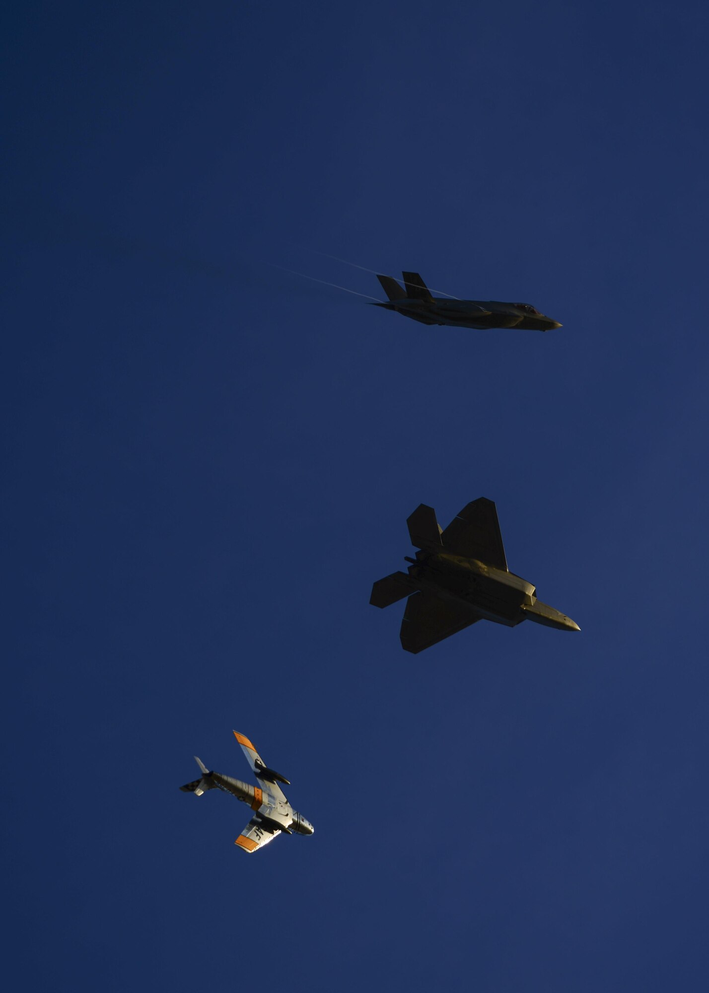 A U.S. Air Force F-22 Raptor, F-35 Lightning II and F-86 Sabre fly in formation during the 2017 Heritage Flight Training and Certification Course at Davis-Monthan Air Force Base, Ariz., Feb. 10, 2017. The 20th annual training event has been held at D-M since 2001 and features aerial demonstrations from historical and modern fighter aircraft. (U.S. Air Force photo by Senior Airman Chris Drzazgowski)
