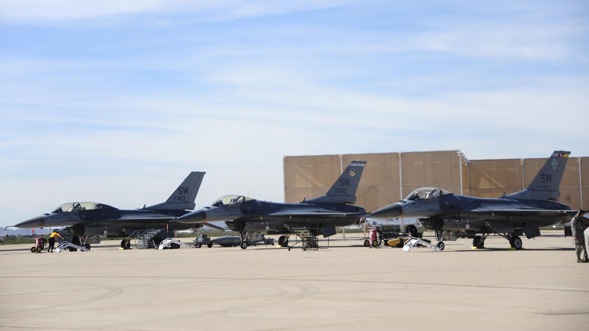 Three U.S. Air Force F-16 Fighting Falcons rest on the flight line during the 2017 Heritage Flight Training and Certification Course at Davis-Monthan Air Force Base, Ariz., Feb. 9, 2017. During the course, aircrews practice ground and flight training to enable civilian pilots of historic military aircraft and U.S. Air Force pilots of current fighter aircraft to safely fly in formations together. (U.S. Air Force Photo by Airman 1st Class Nathan H. Barbour)
