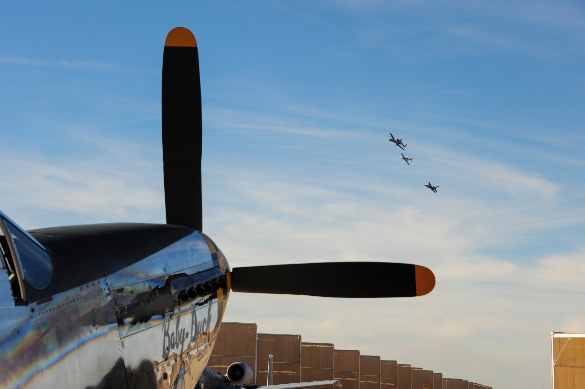 A formation of aircraft fly above a P-51 Mustang during the 2017 Heritage Flight Training and Certification Course at Davis-Monthan Air Force Base, Ariz., Feb. 10, 2017. The annual aerial demonstration training event has been held at D-M since 2001. The modern aircraft that participated in this year's HFTCC were the F-35 Lightning II, the F-22 Raptor, F-16 Fighting Falcon and the A-10C Thunderbolt II. The historic aircraft included the P-51 and T-51 Mustang, P-40 Warhawk, P-38 Lightning, P-47 Thunderbolt, T-33 Shooting Star and F-86 Sabre. (U.S. Air Force Photo by Airman 1st Class Nathan H. Barbour)