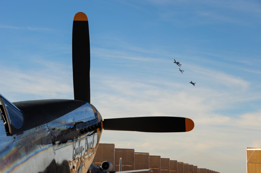 A formation of aircraft fly above a P-51 Mustang during the 2017 Heritage Flight Training and Certification Course at Davis-Monthan Air Force Base, Ariz., Feb. 10, 2017. The annual aerial demonstration training event has been held at D-M since 2001. The modern aircraft that participated in this year's HFTCC were the F-35 Lightning II, the F-22 Raptor, F-16 Fighting Falcon and the A-10C Thunderbolt II. The historic aircraft included the P-51 and T-51 Mustang, P-40 Warhawk, P-38 Lightning, P-47 Thunderbolt, T-33 Shooting Star and F-86 Sabre. (U.S. Air Force Photo by Airman 1st Class Nathan H. Barbour)