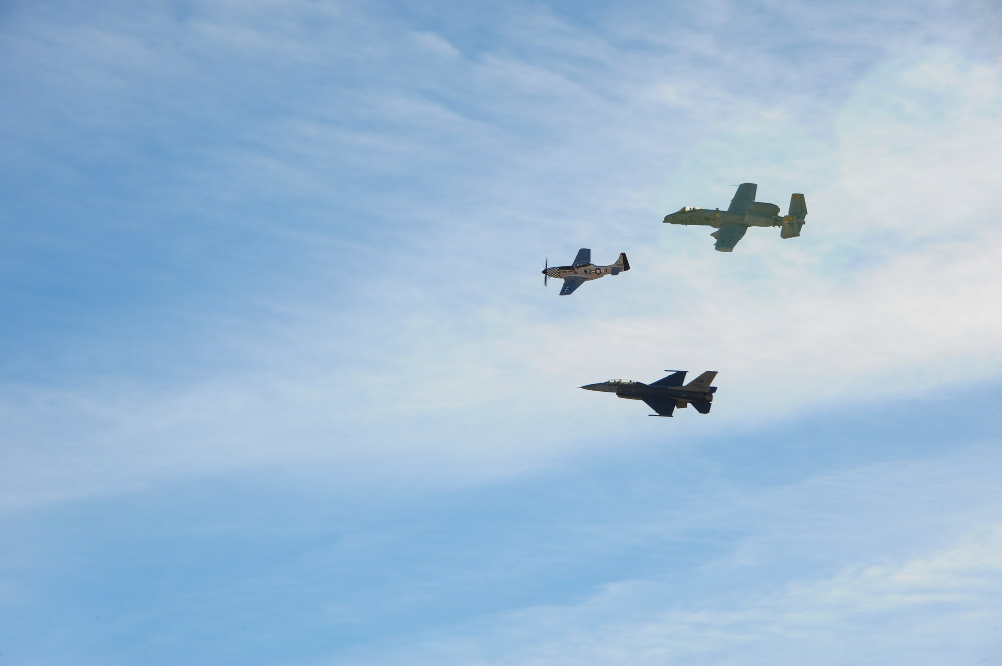 A U.S. Air Force A-10C Thunderbolt II, a P-51 Mustang and an F-16 Fighting Falcon fly in formation during the 2017 Heritage Flight Training and Certification Course at Davis-Monthan Air Force Base, Ariz., Feb. 10, 2017. During the course, aircrews practice ground and flight training to enable civilian pilots of historic military aircraft and U.S. Air Force pilots of current fighter aircraft to safely fly in formations together. (U.S. Air Force Photo by Airman 1st Class Nathan H. Barbour)