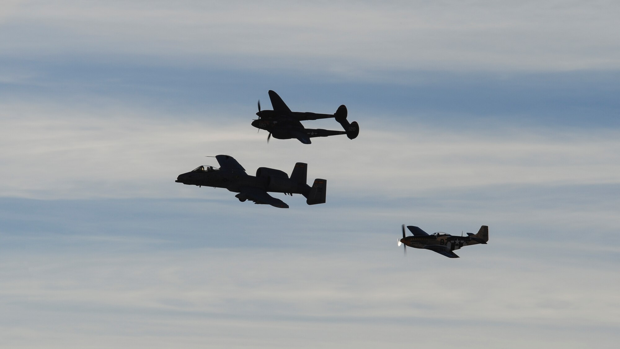 A U.S. Air Force A-10C Thunderbolt II, P-38 Lightning and a P-51 Mustang fly in formation during the 2017 Heritage Flight Training and Certification Course at Davis-Monthan Air Force Base, Ariz., Feb. 10, 2017. During the course, aircrews practice ground and flight training to enable civilian pilots of historic military aircraft and U.S. Air Force pilots of current fighter aircraft to safely fly in formations together. (U.S. Air Force Photo by Airman 1st Class Nathan H. Barbour)