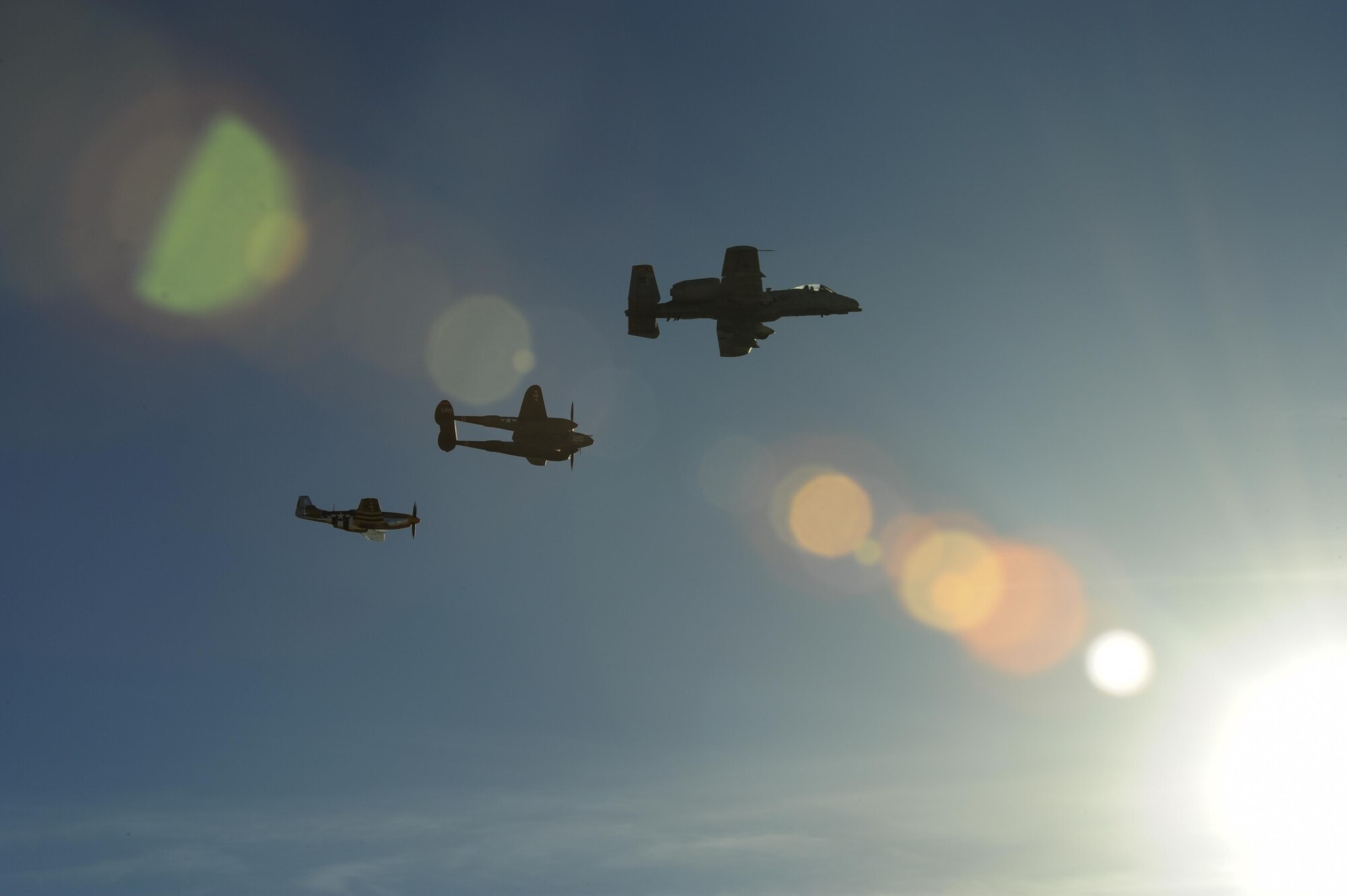 A U.S. Air Force A-10C Thunderbolt II, a P-38 Lightning and a P-51 Mustang fly in formation during the 2017 Heritage Flight Training and Certification Course at Davis-Monthan Air Force Base, Ariz., Feb. 10, 2017. The annual aerial demonstration training event has been held at D-M since 2001 and featured aerial demonstrations from historical and modern fighter aircraft. (U.S. Air Force Photo by Airman 1st Class Nathan H. Barbour)
