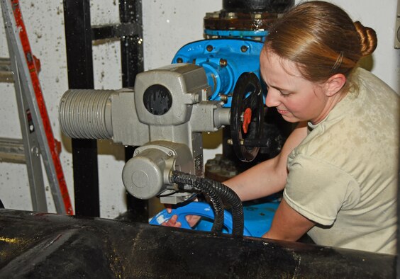 U.S. Air Force Senior Airman Lillian Skowvron, a water and fuels technician with the 379th Expeditionary Civil Engineer Squadron water and fuels section, loosens a pipe at Al Udeid Air Base, Qatar, Feb. 9, 2017. Water and fuels section Airmen are responsible for inspecting and maintaining all water and sewer operations on Al Udeid AB. (U.S. Air Force photo by Senior Airman Cynthia A. Innocenti)