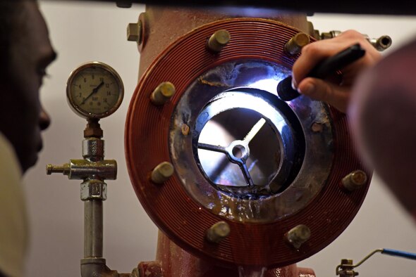 U.S. Air Force Airmen with the 379th Expeditionary Civil Engineer Squadron water and fuels section, inspect a pipe at Al Udeid Air Base, Qatar, Feb. 9, 2017. These Airmen install, inspect, maintain, troubleshoot and modify all repairs dealing with water and sewer operations at Al Udeid AB. (U.S. Air Force photo by Senior Airman Cynthia A. Innocenti)