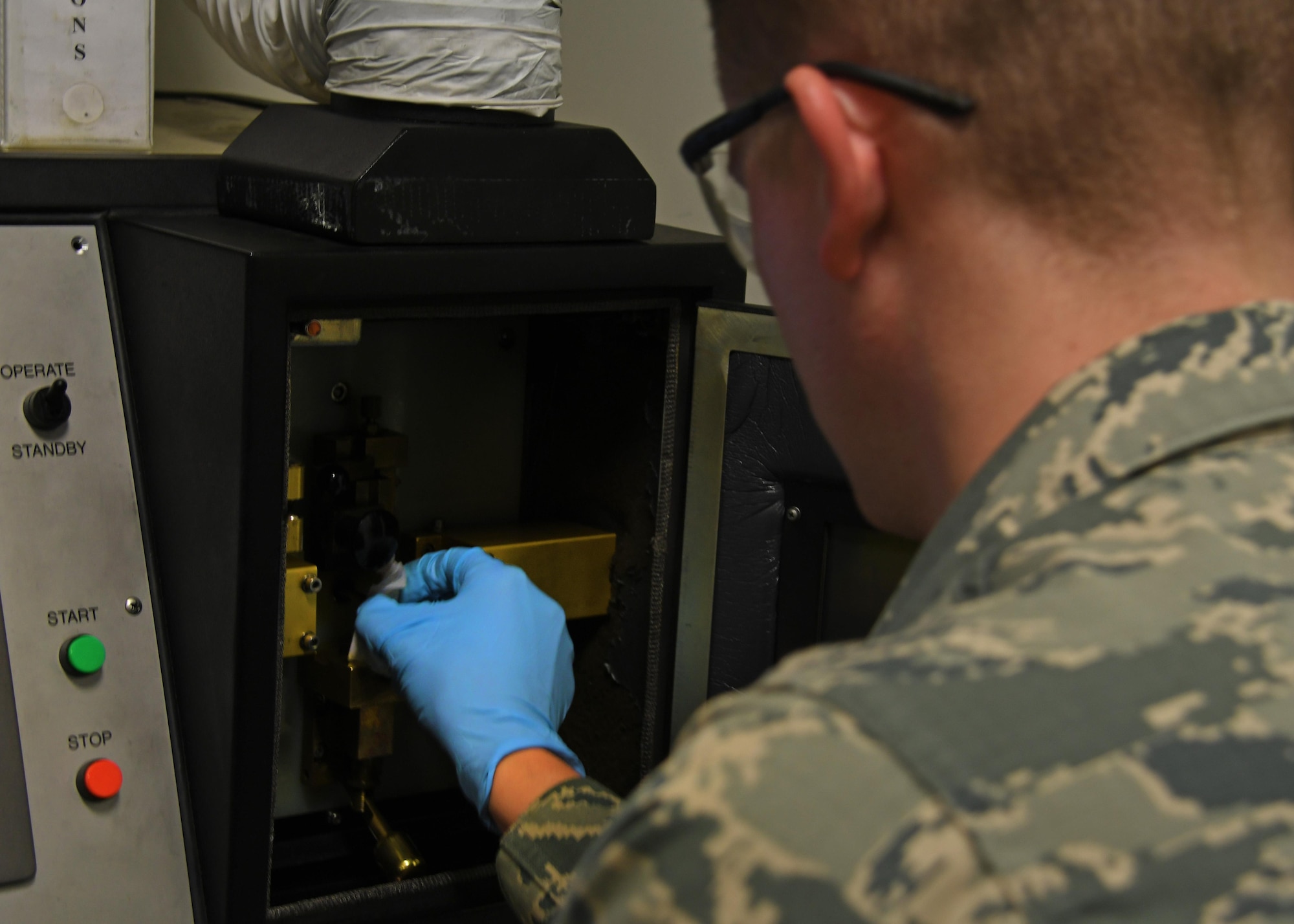 U.S. Air Force Airman 1st Class Travis Nevison, a non-destructive inspection journeyman with the 379th Expeditionary Maintenance Squadron Fabrication Flight, prepares to burn a test oil sample at Al Udeid Air Base, Qatar, Feb. 9, 2017. The joint oil analysis program utilizes oil samples gathered from aircraft to determine the wear and tear on internal parts of the engine without having to break it down completely. (U.S. Air Force photo by Senior Airman Miles Wilson)