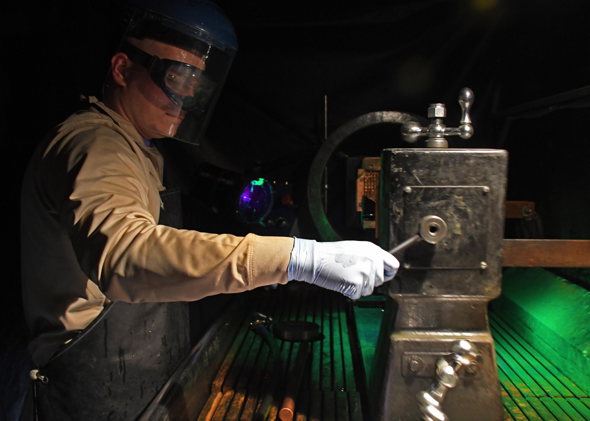 U.S. Air Force Airman 1st Class Austin Hall, a non-destructive inspection journeyman with the 379th Expeditionary Maintenance Squadron Fabrication Flight, prepares the magnetic inspection unit for a fluorescent penetrant inspection at Al Udeid Air Base, Qatar, Feb. 9, 2017. Hall conducted a magnetic particle inspection to look for defects in a piece of metal. (U.S. Air Force photo by Senior Airman Miles Wilson)