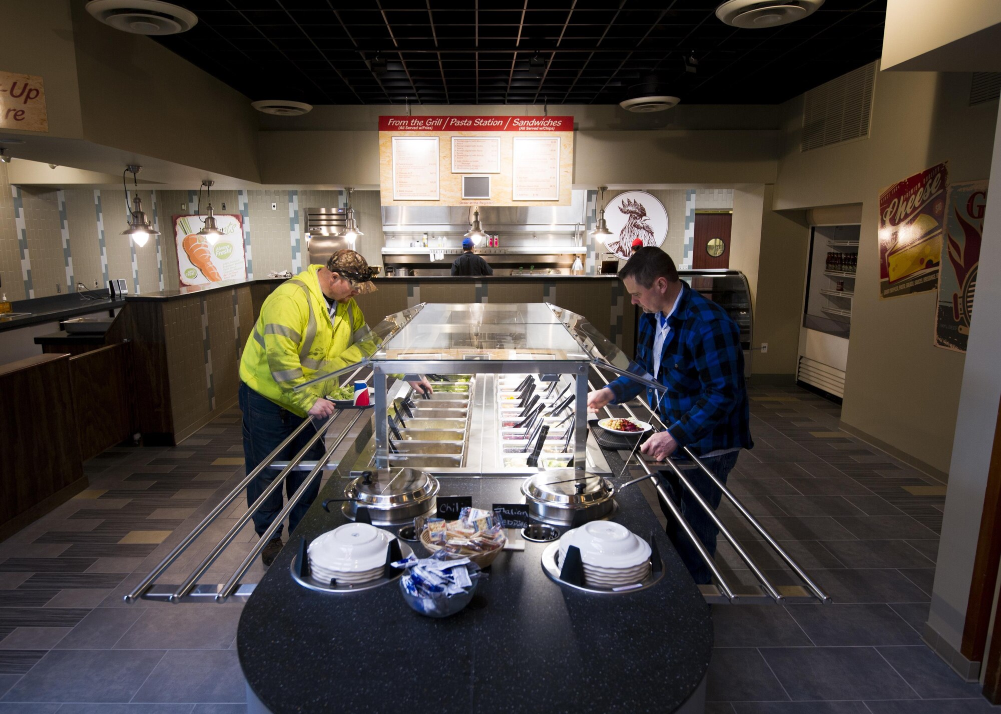 Customers get lunch from the grill located inside the McChord Field Club on Joint Base Lewis-McChord, Feb. 10. The newly renovated McChord Pub is now open inside the club on UTA Saturdays from 1600 to 2100, as well as Thursdays and Fridays. The pub will provide Citizen Airmen with alternative dining options and a place to order drinks during UTA weekends. (U.S. Air Force photo by SSgt. Daniel Liddicoet)