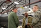 Retired Lt. Col. James H. Harvey III (center), member of the historic Tuskegee Airmen, talks to Col. David Smith, 419th Fighter Wing commander, and Tech. Sgt. David Batman, 419th Aircraft Maintenance Squadron, about the F-16 Fighting Falcon during a tour at Hill Air Force Base Feb. 11. (U.S. Air Force photo/Bryan Magaña)