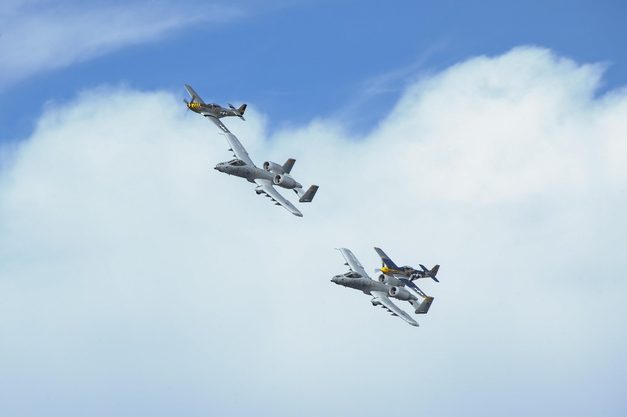 Two U.S. Air Force A-10C Thunderbolt IIs, a P-51 Mustang and a P-40 Warhawk fly in formation during the 2017 Heritage Flight Training and Certification Course at Davis-Monthan Air Force Base, Ariz., Feb. 10, 2017. The historic aircraft included the P-51 and T-51 Mustang, the P-40 Warhawk, the P-38 Lightning, the P-47 Thunderbolt, the T-33 Shooting Star and the F-86 Sabre. (U.S. Air Force photo by Airman 1st Class Mya M. Crosby)