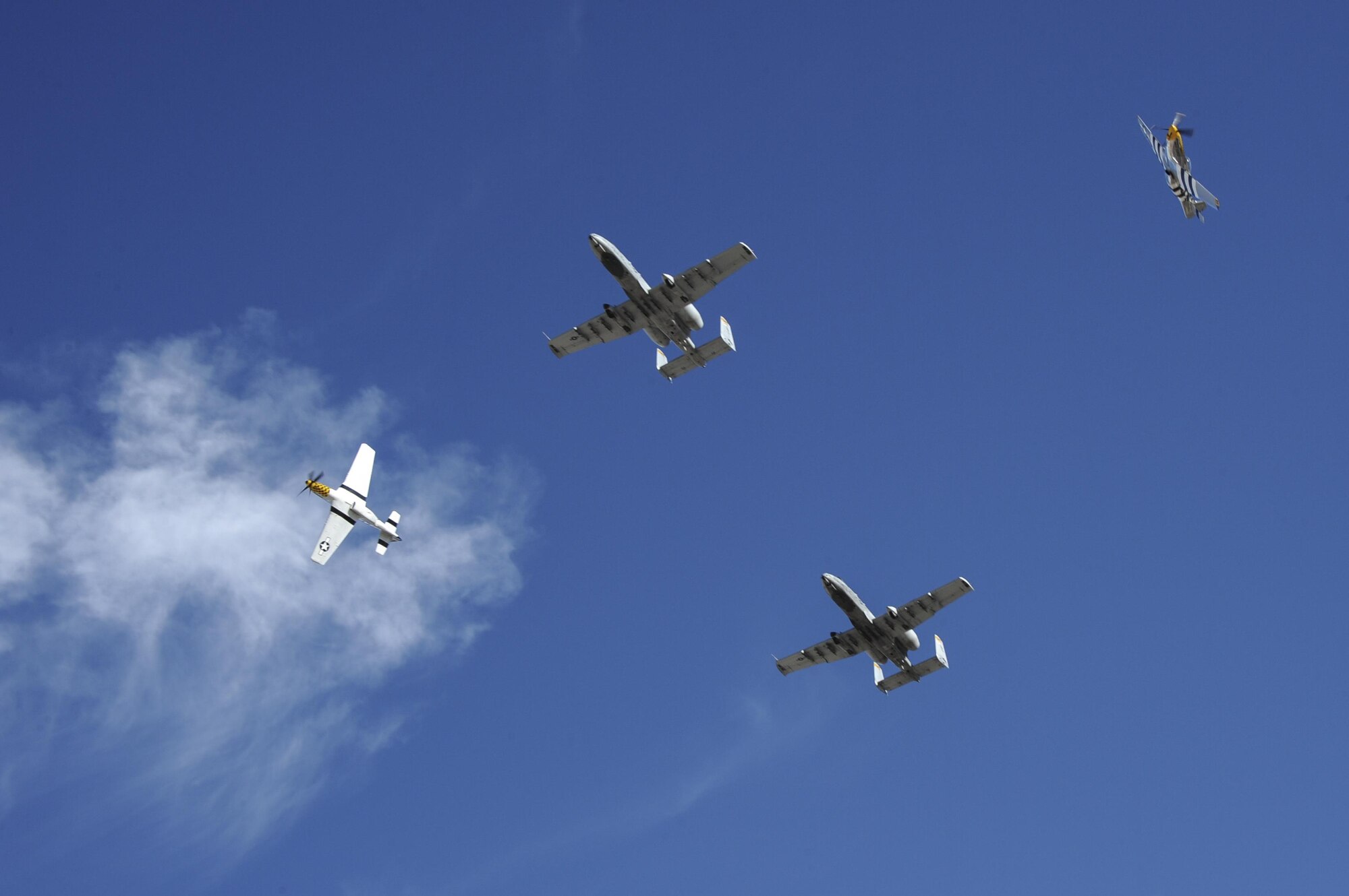 Two U.S. Air Force A-10C Thunderbolt IIs, a P-51 Mustang and a P-40 Warhawk fly in formation during the 2017 Heritage Flight Training and Certification Course at Davis-Monthan Air Force Base, Ariz., Feb. 10, 2017. The modern aircraft that participated in this year's HFTCC were the F-35 Lightning II, the F-22 Raptor, F-16 Fighting Falcon and the A-10C Thunderbolt II. (U.S. Air Force photo by Airman 1st Class Mya M. Crosby)