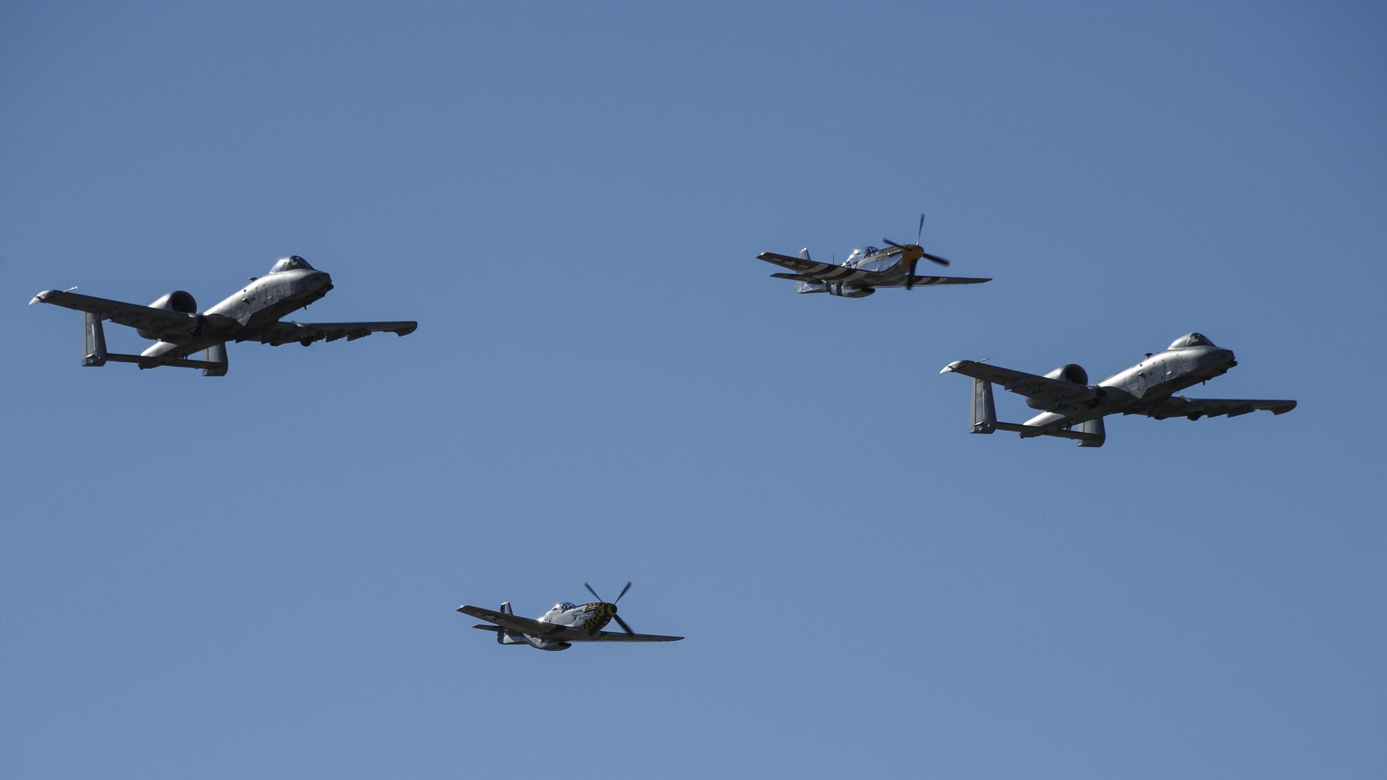 Two U.S. Air Force A-10C Thunderbolt IIs, a P-51 Mustang and a P-40 Warhawk fly in formation during the 2017 Heritage Flight Training and Certification Course at Davis-Monthan Air Force Base, Ariz., Feb. 10, 2017. The historic aircraft included the P-51 and T-51 Mustang, the P-40 Warhawk, the P-38 Lightning, the P-47 Thunderbolt, the T-33 Shooting Star and the F-86 Sabre. (U.S. Air Force photo by Airman 1st Class Mya M. Crosby)