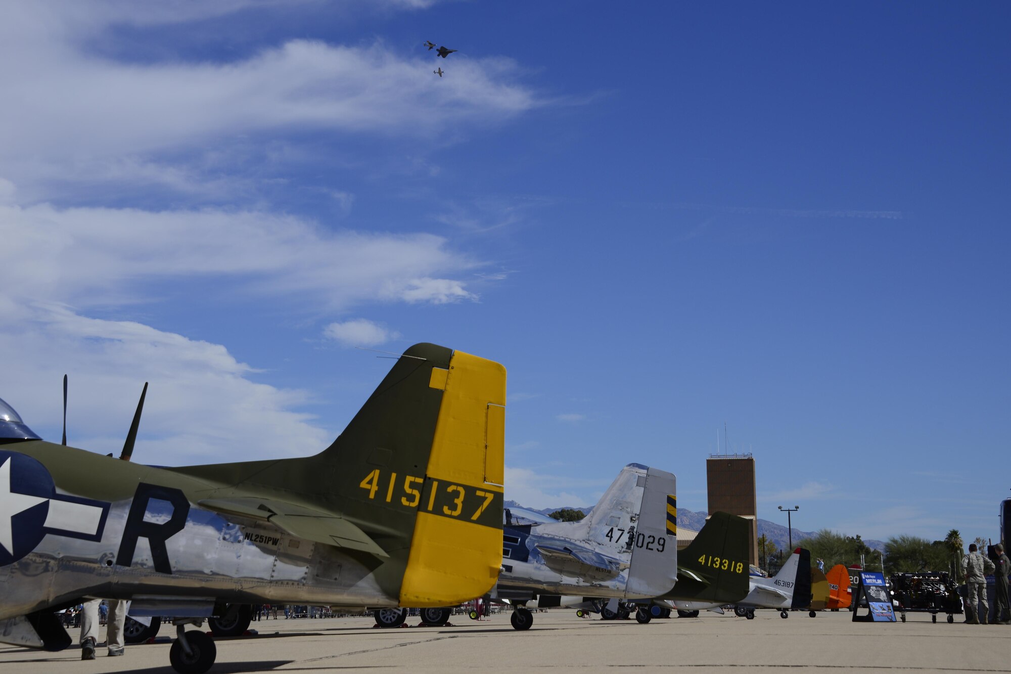 A U.S. Air Force F-22 Raptor, a F-86 Sabre and a P-51 Mustang fly in formation over historic aircraft during the 2017 Heritage Flight Training and Certification Course at Davis-Monthan Air Force Base, Ariz., Feb. 11, 2017. The modern aircraft that participated in this year’s HFTCC were the F-35 Lightning II, the F-22 Raptor, F-16 Fighting Falcon and the A-10C Thunderbolt II. The historic aircraft included the P-51 and T-51 Mustangs, the P-40 Warhawk, the P-38 Lightning, the P-47 Thunderbolt, the T-33 Shooting Star and the F-86 Sabre. (U.S. Air Force photo by Senior Airman Betty R. Chevalier)