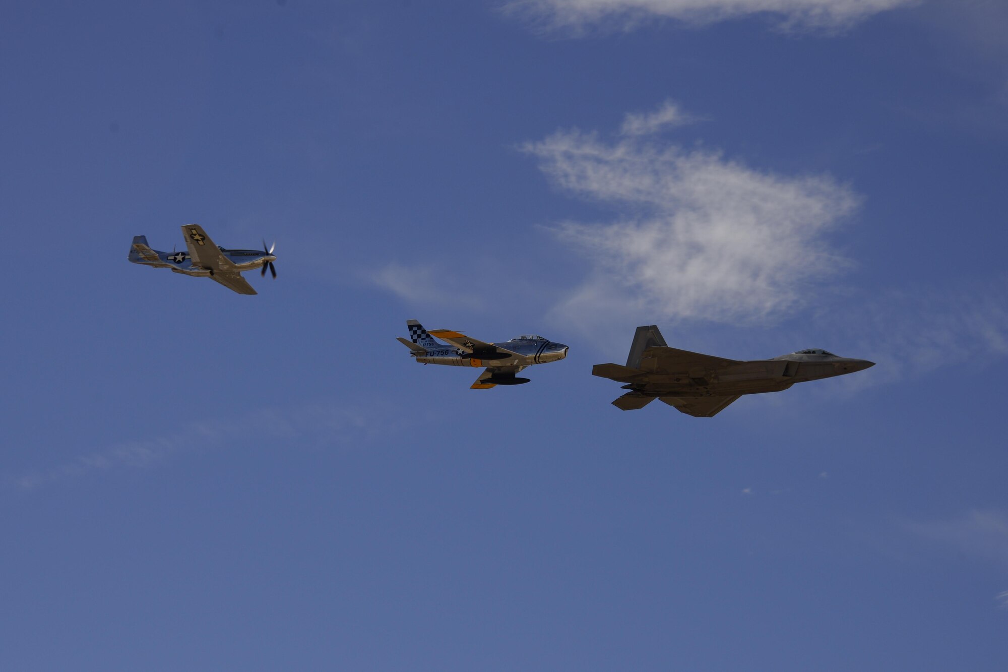 A U.S. Air Force F-22 Raptor, a F-86 Sabre and a P-51 Mustang fly in formation during the 2017 Heritage Flight Training and Certification Course at Davis-Monthan Air Force Base, Ariz., Feb. 11, 2017.  During the course, aircrews practice ground and flight training to enable civilian pilots of historic military aircraft and U.S. Air Force pilots of current fighter aircraft to fly safely in formations together. (U.S. Air Force photo by Senior Airman Betty R. Chevalier)