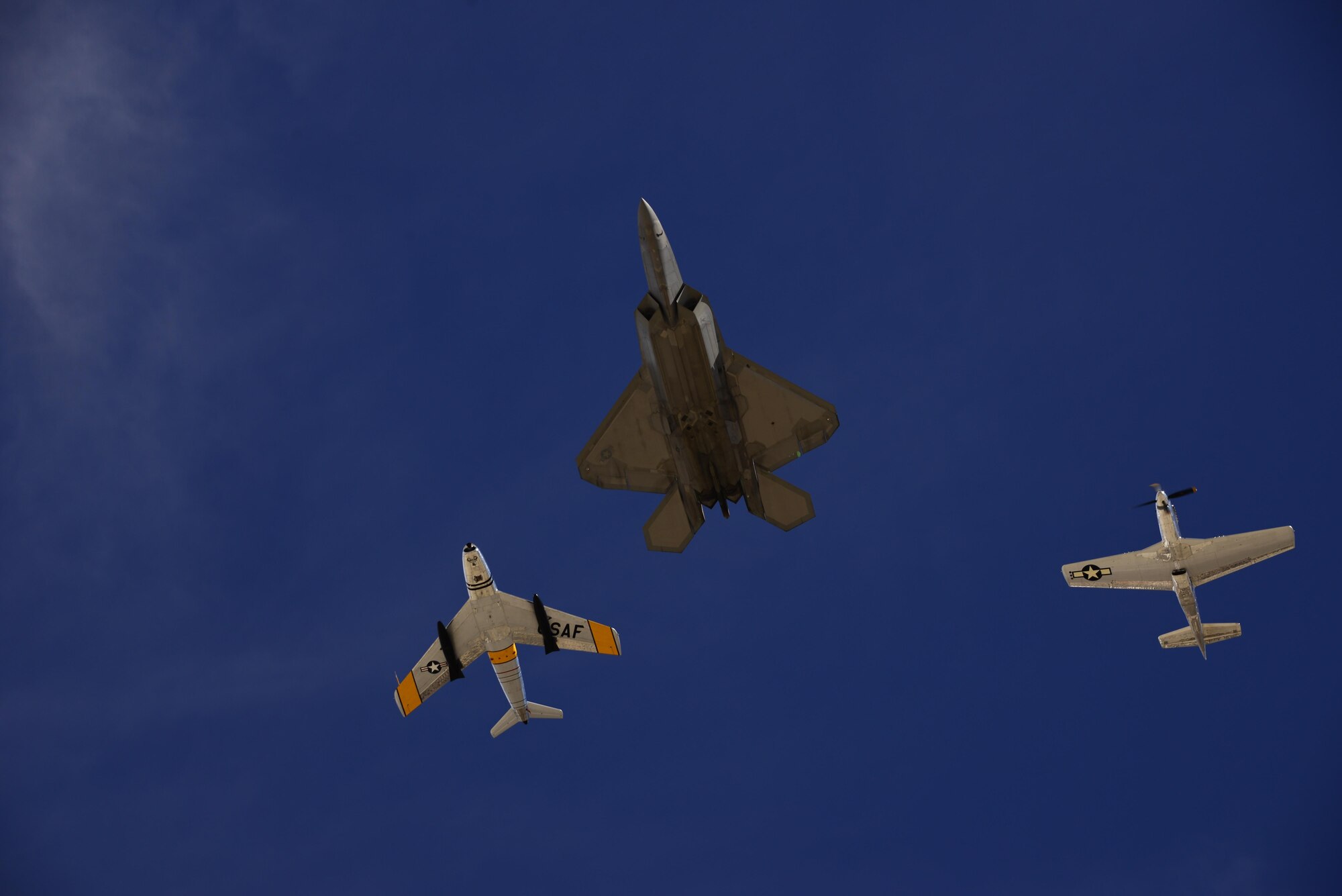 A U.S. Air Force F-22 Raptor, a F-86 Sabre and a P-51 Mustang fly in formation during the 2017 Heritage Flight Training and Certification Course at Davis-Monthan Air Force Base, Ariz., Feb. 11, 2017.  The annual aerial demonstration training event has been held at D-M since 2001. The course featured aerial demonstrations from historic and modern fighter aircraft. (U.S. Air Force photo by Senior Airman Betty R. Chevalier)