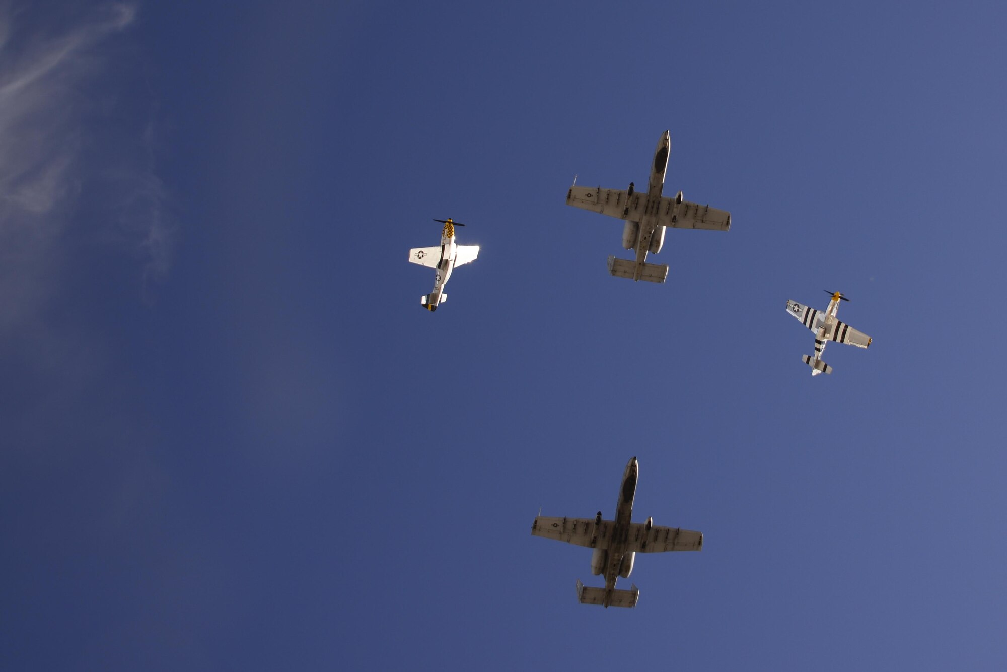 Two U.S. Air Force A-10C Thunderbolt II's and two P-51 Mustang's fly in formation during the 2017 Heritage Flight Training and Certification Course at Davis-Monthan Air Force Base, Ariz., Feb. 11, 2017. The annual aerial demonstration training event has been held at D-M since 2001. The modern aircraft that participated in this year’s HFTCC were the F-35 Lightning II, the F-22 Raptor, F-16 Fighting Falcon and the A-10C Thunderbolt II. The historic aircraft included the P-51 and T-51 Mustangs, the P-40 Warhawk, the P-38 Lightning, the P-47 Thunderbolt, the T-33 Shooting Star and the F-86 Sabre. (U.S. Air Force photo by Senior Airman Betty R. Chevalier)