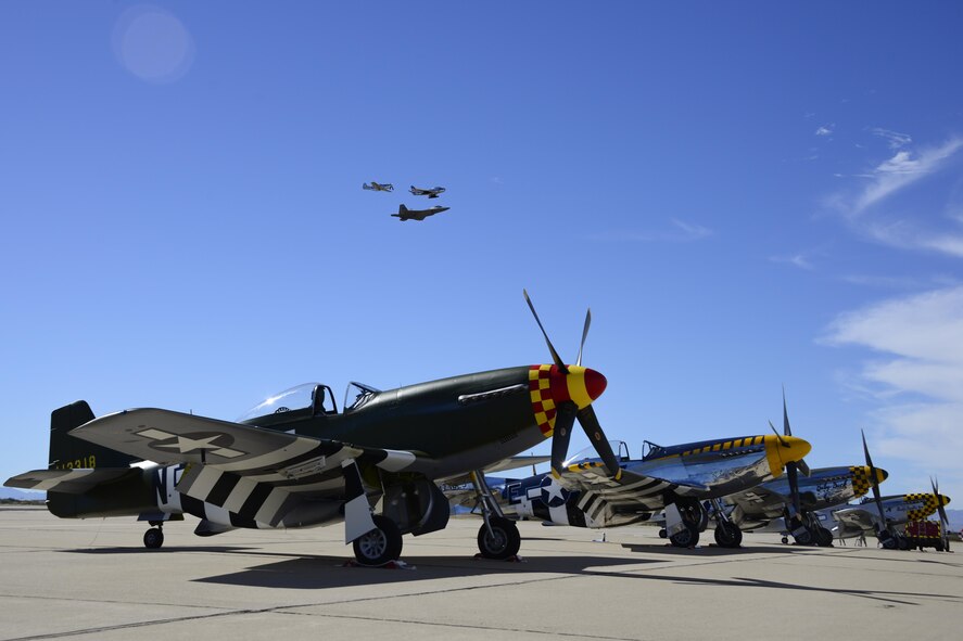A U.S. Air Force F-22 Raptor, a F-86 Sabre and a P-51 Mustang fly in formation over historic aircraft during the 2017 Heritage Flight Training and Certification Course at Davis-Monthan Air Force Base, Ariz., Feb. 11, 2017.Established in 1997, the HFTCC certifies civilian pilots of historic military aircraft and U.S. Air Force pilots to fly in formation together during the upcoming air show season. (U.S. Air Force photo by Senior Airman Betty R. Chevalier)