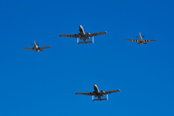 Two U.S. Air Force A-10C Thunderbolt IIs and two P-51 Mustangs fly together during the 2017 Heritage Flight Training and Certification Course at Davis-Monthan Air Force Base, Ariz., Feb. 11, 2017. The 20th annual aerial demonstration training event has been held at D-M since 2001 and features aerial demonstrations from historic and modern fighter aircraft. (U.S. Air Force photo by Senior Airman Cheyenne A. Powers)