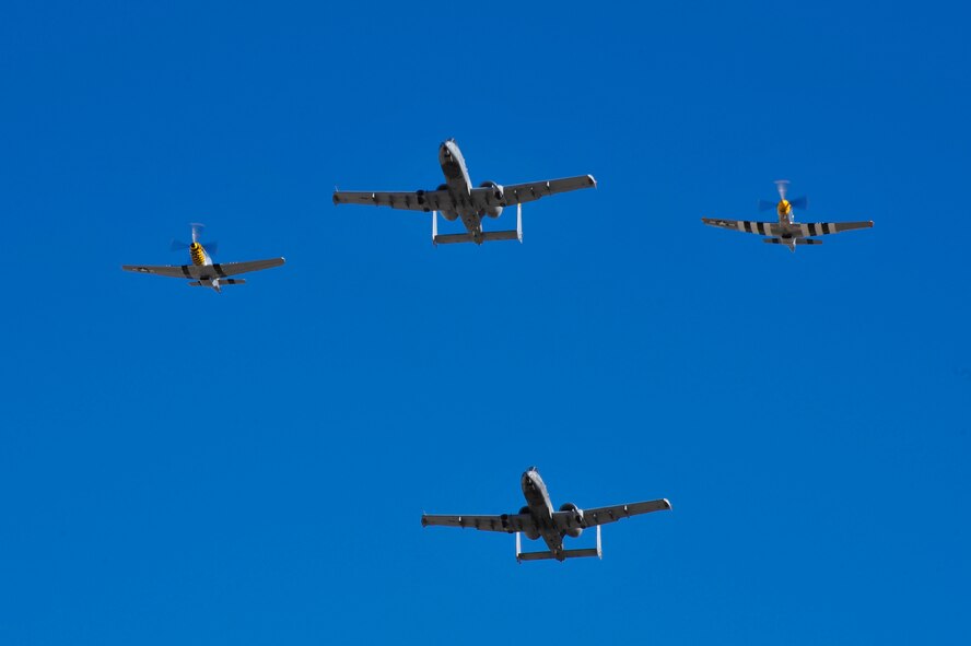 Two U.S. Air Force A-10C Thunderbolt IIs and two P-51 Mustangs fly together during the 2017 Heritage Flight Training and Certification Course at Davis-Monthan Air Force Base, Ariz., Feb. 11, 2017. The 20th annual aerial demonstration training event has been held at D-M since 2001 and features aerial demonstrations from historic and modern fighter aircraft. (U.S. Air Force photo by Senior Airman Cheyenne A. Powers)