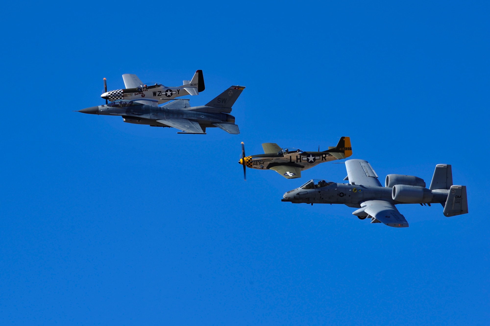 A U.S. Air Force F-16 Fighting Falcon, A-10C Thunderbolt II and two TF-51 Mustangs perform aerial demonstrations during the 2017 Heritage Flight Training and Certification Course at Davis-Monthan Air Force Base, Ariz., Feb. 11, 2017. The annual aerial demonstration training event has been held at D-M since 2001. The modern aircraft that participated in this year’s HFTCC were the F-35 Lightning II, the F-22 Raptor, F-16 Fighting Falcon and the A-10C Thunderbolt II. The historic aircraft included the P-51 and T-51 Mustangs, the P-40 Warhawk, the P-38 Lightning, the P-47 Thunderbolt, the T-33 Shooting Star and the F-86 Sabre. (U.S. Air Force photo by Senior Airman Cheyenne A. Powers)
