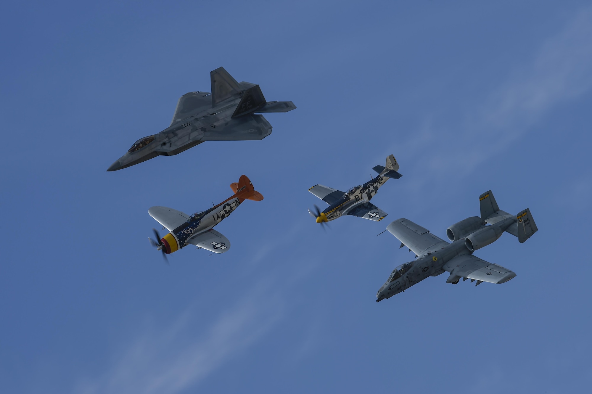 A U.S. Air Force F-22 Raptor, A-10C Thunderbolt II, a P-47 Thunderbolt and P-51 Mustang fly in formation during the 2017 Heritage Flight Training and Certification Course at Davis-Monthan Air Force Base, Ariz., Feb. 11, 2017. The 20th annual training event has been held at D-M since 2001 and features aerial demonstrations from historical and modern fighter aircraft. (U.S. Air Force photo by Senior Airman Chris Drzazgowski)