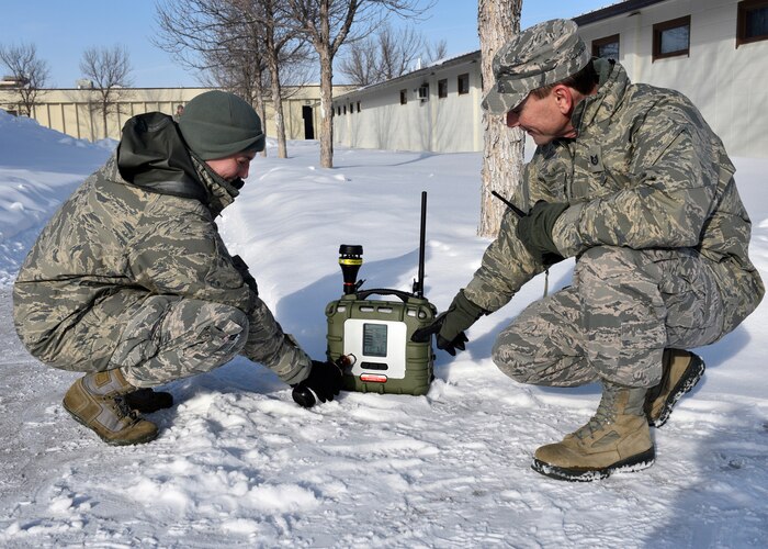 Senior Master Sgt. Amber Westie, 120th Medical Group bioenvironmental superintendent, waves gasoline beneath the sensor of the Area RAE pro, a long range contaminant detection monitor while Technical Sgt. Marcus Jackson, 120th Airlift Wing readiness and emergency management flight specialist, verifies the alarm was tripped. Stateside Guard unit’s readiness and emergency management flights each received a Rapid Deployment Kit from National Guard Bureau. (U.S. Air National Guard photo by Staff Sgt. Lindsey Soulsby/Released)