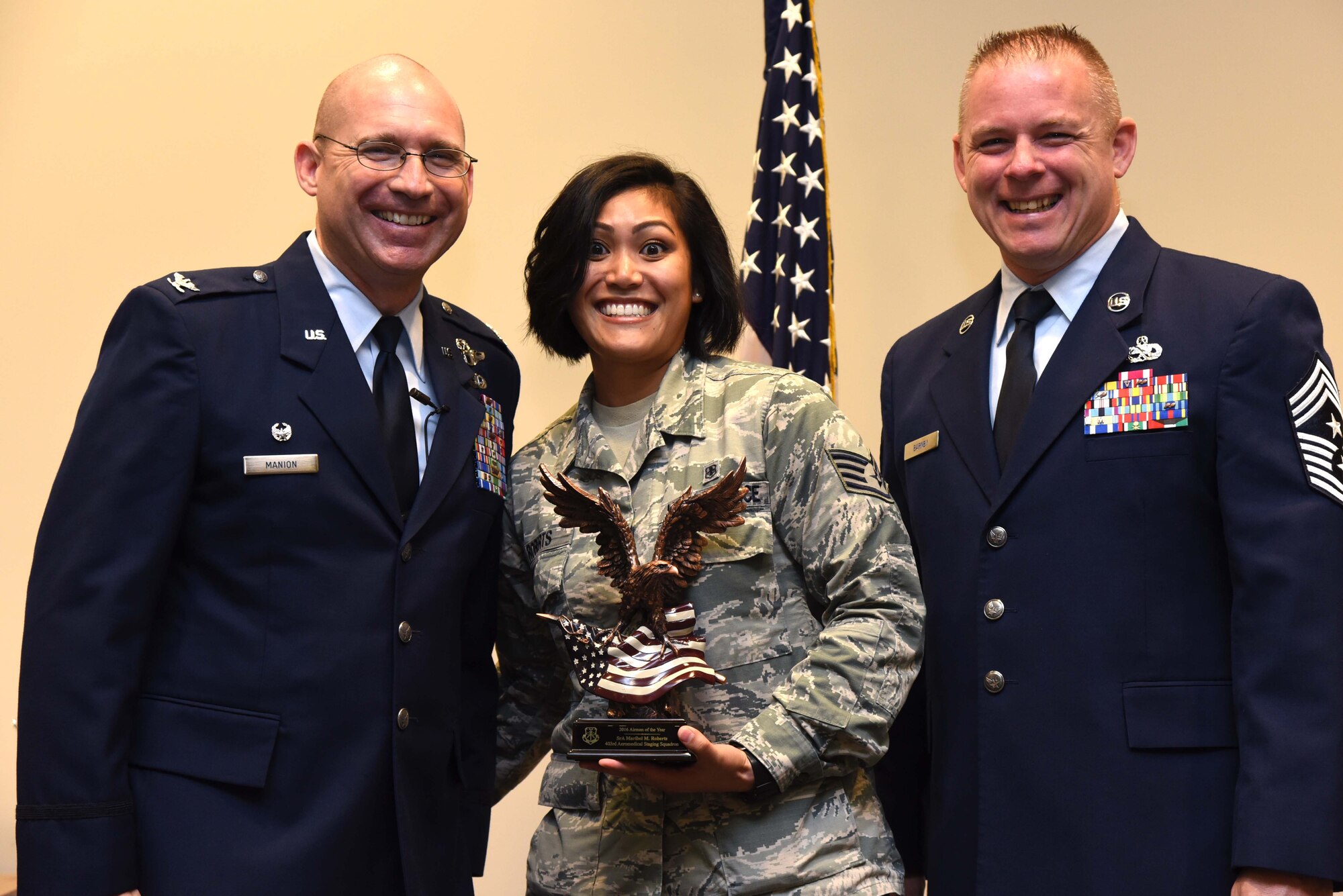 Col. Michael Manion, 403rd Wing commander, and Chief Master Sgt. Christopher Barnby, 403rd Wing command chief master sergeant, present the 403rd Wing 2016 Airman of the Year award to Staff Sgt. Maribel Roberts, 403rd Aeromedical Staging Squadron medical technician. The award presentation took place Feb. 10, 2017, at the 403rd Wing commander’s call held at Keesler Air Force Base, Mississippi. (U.S. Air Force photo/Tech. Sgt. Ryan Labadens)