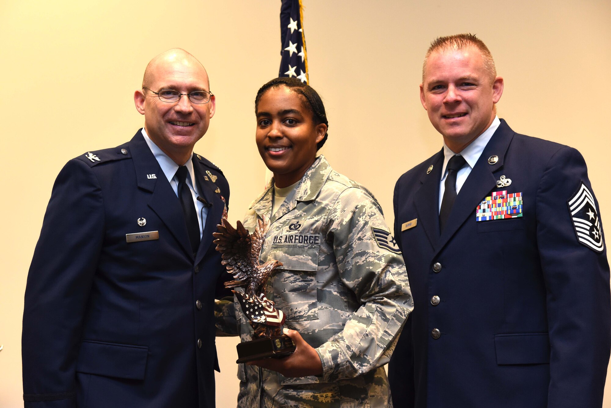 Col. Michael Manion, 403rd Wing commander, and Chief Master Sgt. Christopher Barnby, 403rd Wing command chief master sergeant, present the 403rd Wing 2016 Airman of the Year award to Staff Sgt. Jeranda Boykin, 815th Airlift Squadron aviation resource manager. The award presentation took place Feb. 10, 2017, at the 403rd Wing commander’s call held at Keesler Air Force Base, Mississippi. (U.S. Air Force photo/Tech. Sgt. Ryan Labadens)