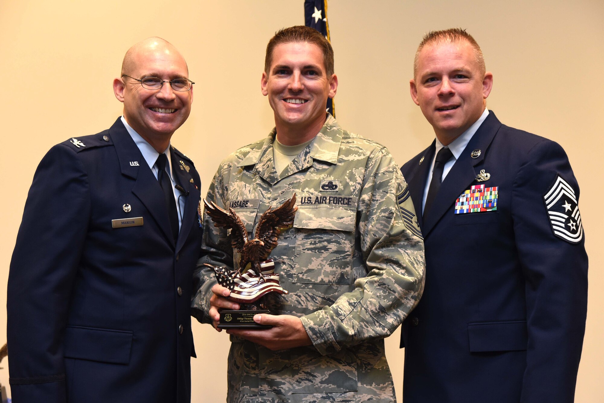 Col. Michael Manion, 403rd Wing commander, and Chief Master Sgt. Christopher Barnby, 403rd Wing command chief master sergeant, present the 403rd Wing 2016 Airman of the Year award to Senior Master Sgt. Thomas Lassabe, 403rd Maintenance Squadron assistant fabrication flight chief. The award presentation took place Feb. 10, 2017, at the 403rd Wing commander’s call held at Keesler Air Force Base, Mississippi. (U.S. Air Force photo/Tech. Sgt. Ryan Labadens)