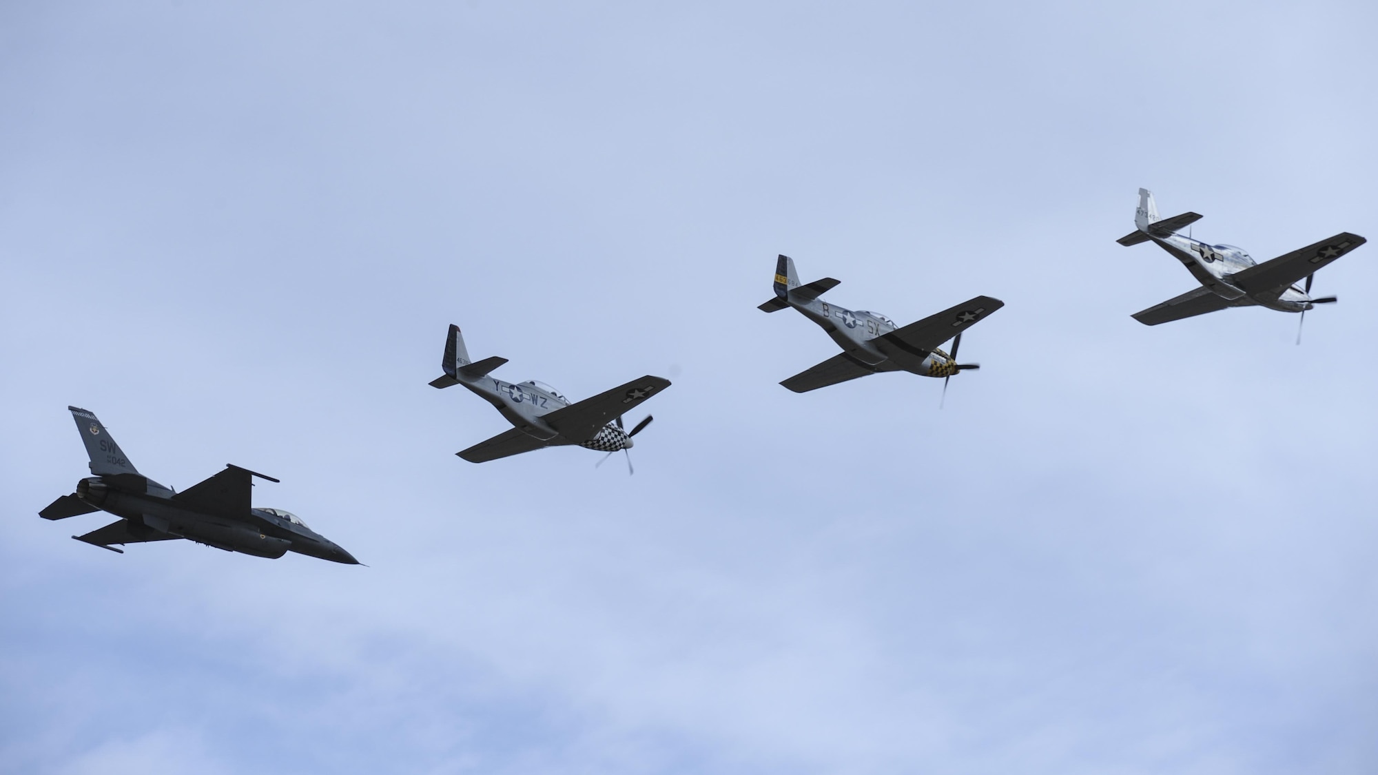 A U.S. Air Force F-16C Fighting Falcon, two P-51 Mustangs and a TF-51 Mustang fly in formation during the 2017 Heritage Flight Training and Certification Course at Davis-Monthan Air Force Base, Ariz., Feb. 12, 2017. The historic aircraft included the P-51 and T-51 Mustangs, the P-40 Warhawk, the P-38 Lightning, the P-47 Thunderbolt, the T-33 Shooting Star and the F-86 Sabre. (U.S. Air Force photo by Airman 1st Class Mya M. Crosby)