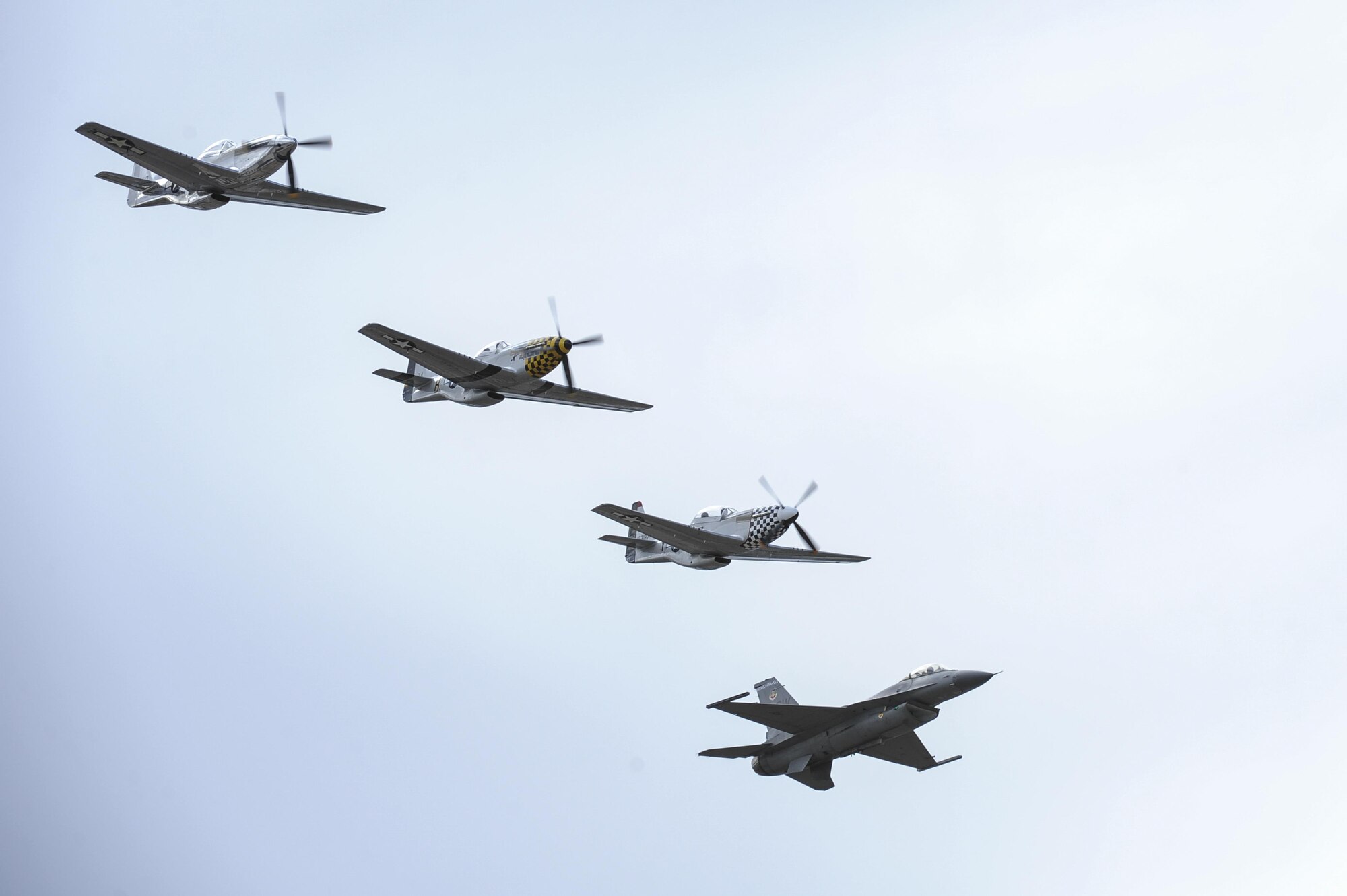 A U.S. Air Force F-16C Fighting Falcon, two P-51 Mustangs and a TF-51 Mustang fly in formation during the 2017 Heritage Flight Training and Certification Course at Davis-Monthan Air Force Base, Ariz., Feb. 12, 2017. The historic aircraft included the P-51 and T-51 Mustang, the P-40 Warhawk, the P-38 Lightning, the P-47 Thunderbolt, the T-33 Shooting Star and the F-86 Sabre. (U.S. Air Force photo by Airman 1st Class Mya M. Crosby)
