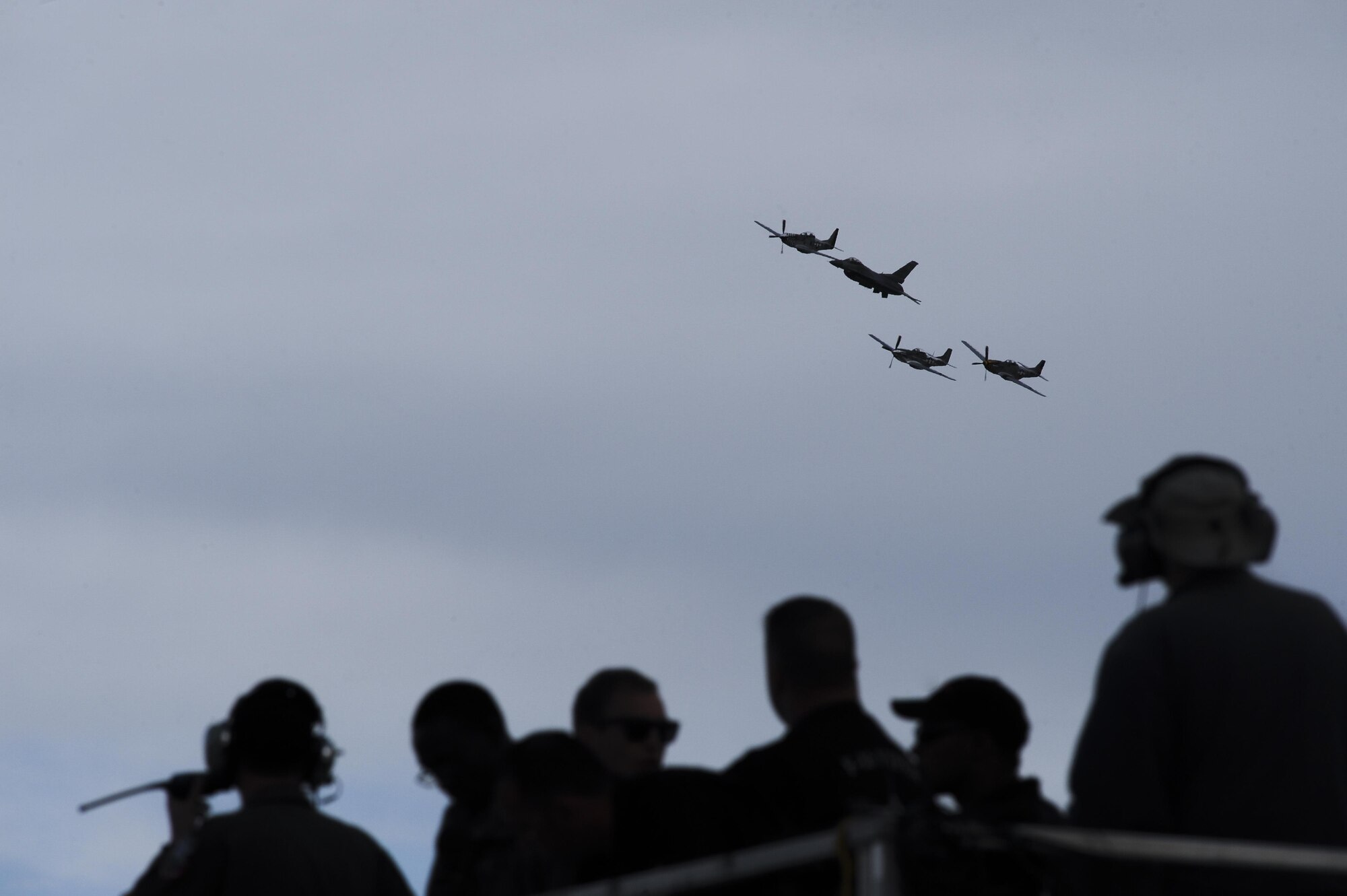 A U.S. Air Force F-16 Fighting Falcon, a TF-51 Mustang and two P-51 Mustangs fly in formation during the 2017 Heritage Flight Training and Certification Course at Davis-Monthan Air Force Base, Ariz., Feb. 12, 2017. The HFTCC provides civilian and military pilots the opportunity to practice flying in formation together in preparation for future air shows. (U.S. Air Force photo by Senior Airman Ashley N. Steffen)