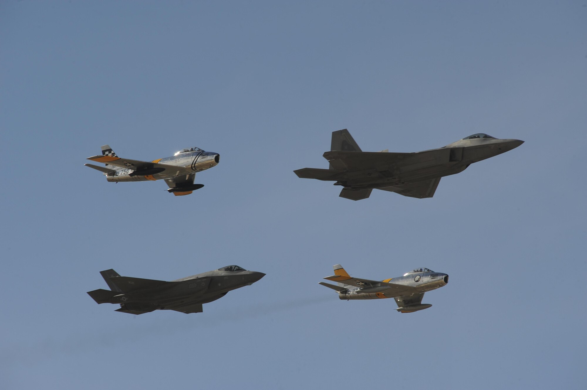 A U.S. Air Force F-35 Lightning II and an F-22 Raptor fly in formation with two F-86 Sabres during the 2017 Heritage Flight Training and Certification Course at Davis-Monthan Air Force Base, Ariz., Feb. 12, 2017. During the course, aircrews practice ground and flight training to enable civilian pilots of historic military aircraft and U.S. Air Force pilots of current fighter aircraft to fly safely in formations together. (U.S. Air Force photo by Senior Airman Ashley N. Steffen)