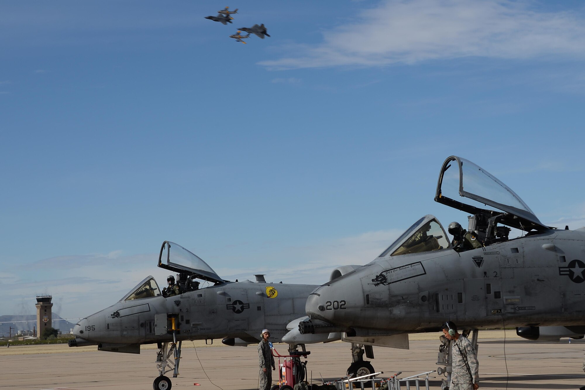 A U.S. Air Force F-35 Lightning II, an F-22 Raptor and two F-86 Sabres fly in formation over two A-10C Thunderbolt IIs during the 2017 Heritage Flight Training and Certification Course at Davis-Monthan Air Force Base, Ariz., Feb. 12, 2017. The annual aerial demonstration training event has been held at D-M since 2001. (U.S. Air Force photo by Senior Airman Ashley N. Steffen)