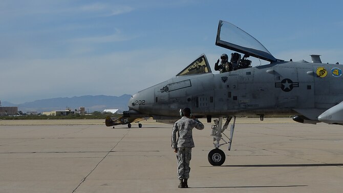 A U.S. Airman salutes an A-10C Thunderbolt II pilot as he taxis down the flightline during the 2017 Heritage Flight Training and Certification Course at Davis-Monthan Air Force Base, Ariz., Feb. 12, 2017. Established in 1997, the HFTCC certifies civilian pilots of historic military aircraft and U.S. Air Force pilots to fly in formation together during the upcoming air show season. (U.S. Air Force photo by Senior Airman Ashley N. Steffen)