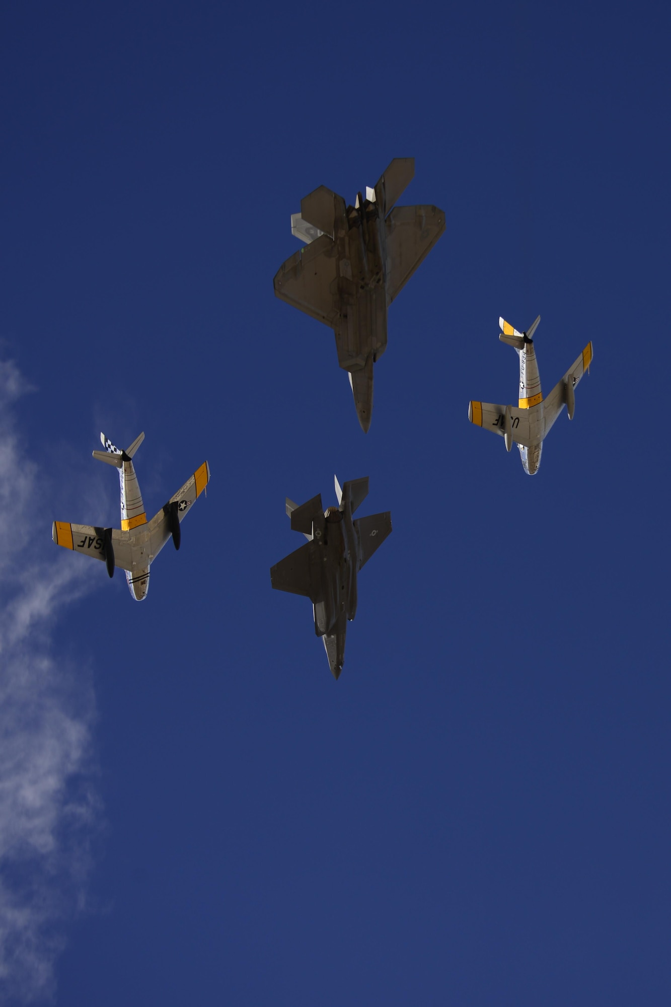 A U.S. Air Force F-22 Raptor, a F-35 Lightning II and two F-86 Sabre's fly in formation during the 2017 Heritage Flight Training and Certification Course at Davis-Monthan Air Force Base, Ariz., Feb. 12, 2017. During the course, aircrews practice ground and flight training to enable civilian pilots of historic military aircraft and U.S. Air Force pilots of current fighter aircraft to fly safely in formations together. (U.S. Air Force photo by Senior Airman Betty R. Chevalier)