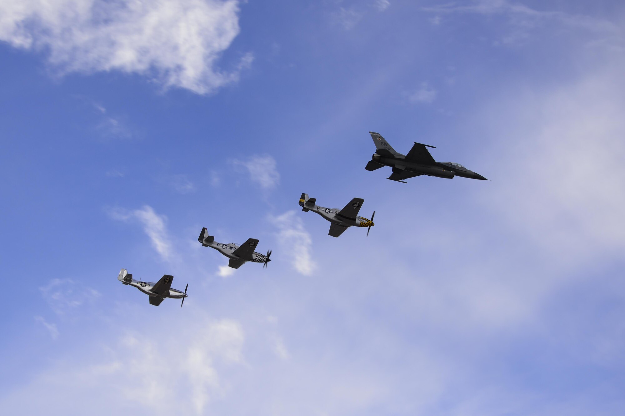 A U.S. Air Force F-16C Fighting Falcon, A TF-51 Mustang and two P-51 Mustangs fly in formation during the 2017 Heritage Flight Training and Certification Course at Davis-Monthan Air Force Base, Ariz., Feb. 12, 2017.  During the course, aircrews practice ground and flight training to enable civilian pilots of historic military aircraft and U.S. Air Force pilots of current fighter aircraft to fly safely in formations together. (U.S. Air Force photo by Senior Airman Betty R. Chevalier)