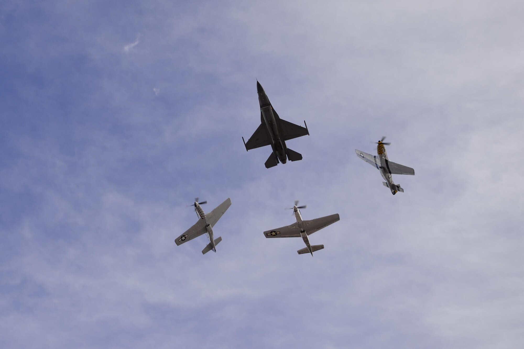A U.S. Air Force F-16C Fighting Falcon, A TF-51 Mustang and two P-51 Mustangs fly in formation during the 2017 Heritage Flight Training and Certification Course at Davis-Monthan Air Force Base, Ariz., Feb. 12, 2017.  Established in 1997, the HFTCC certifies civilian pilots of historic military aircraft and U.S. Air Force pilots to fly in formation together during the upcoming air show season. (U.S. Air Force photo by Senior Airman Betty R. Chevalier)